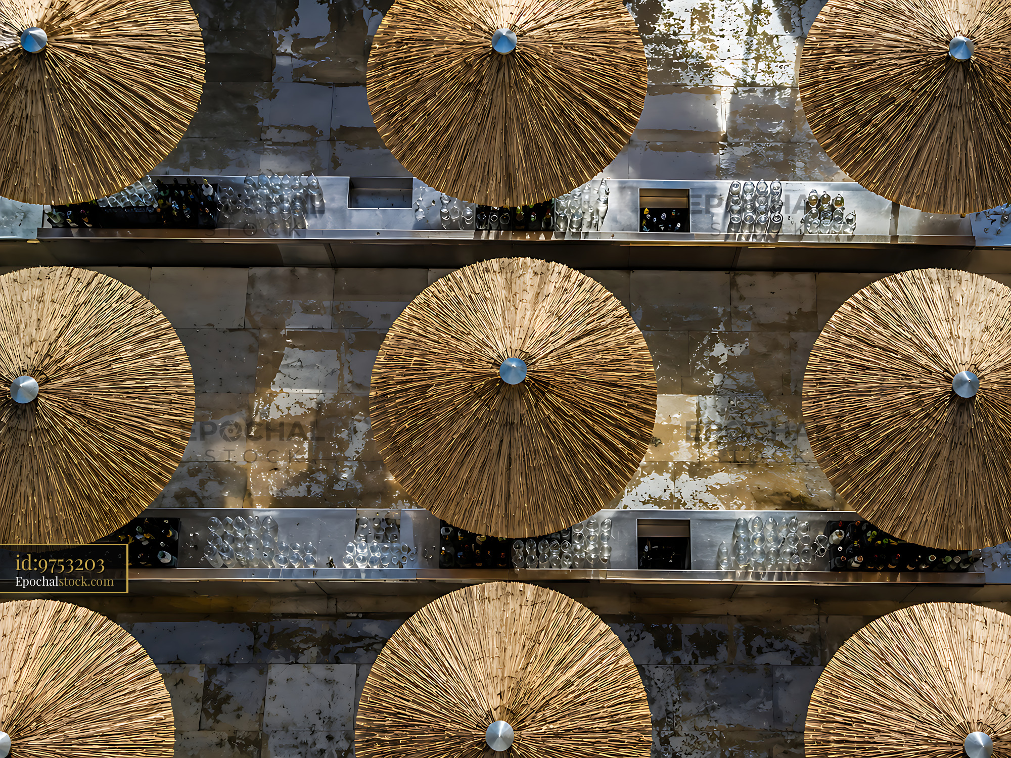 Watermarked full-resolution preview of Roof of straw umbrellas arranged in a pattern
