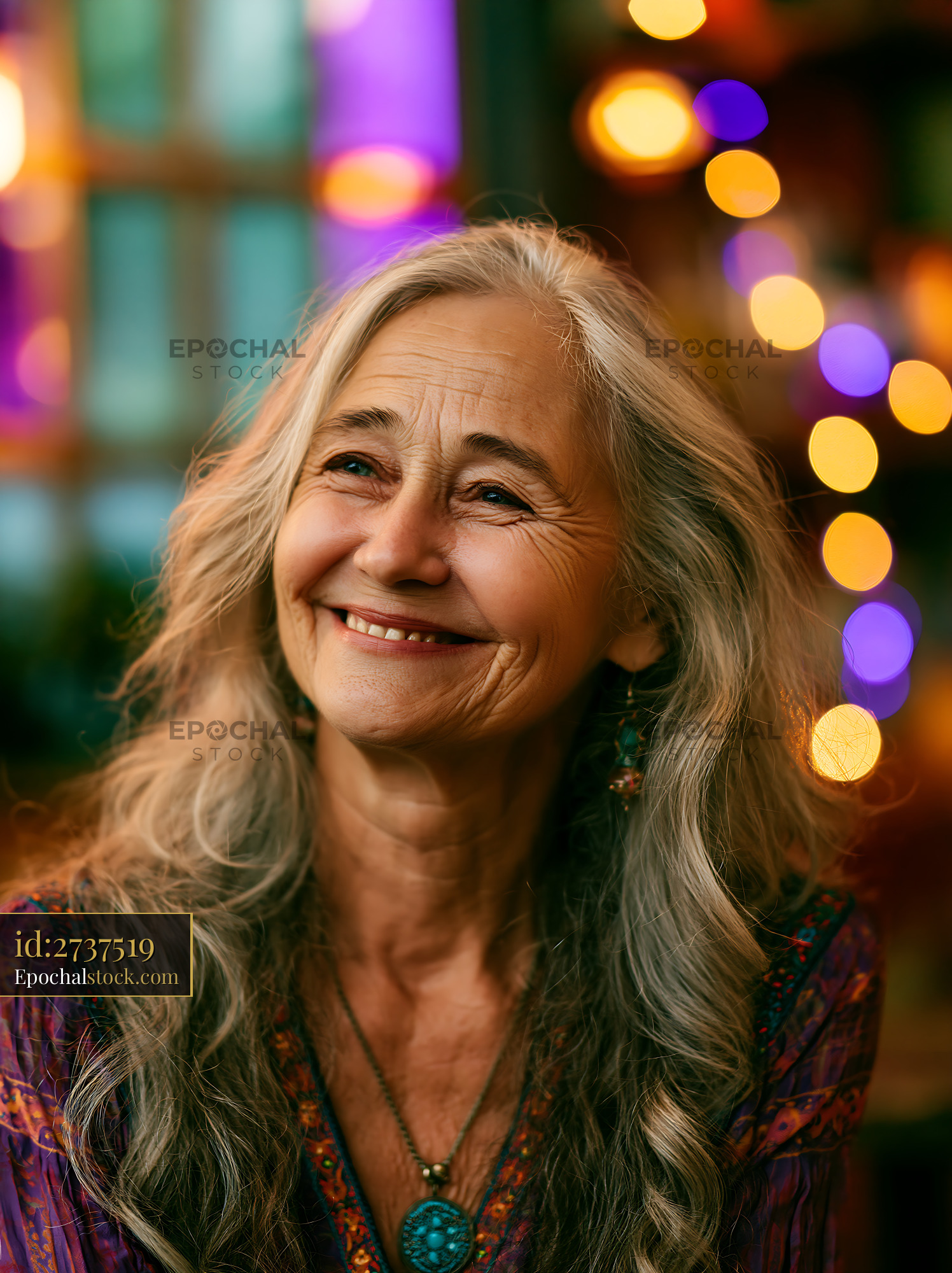 Watermarked full-resolution preview of Smiling woman with long gray hair in a colorful setting