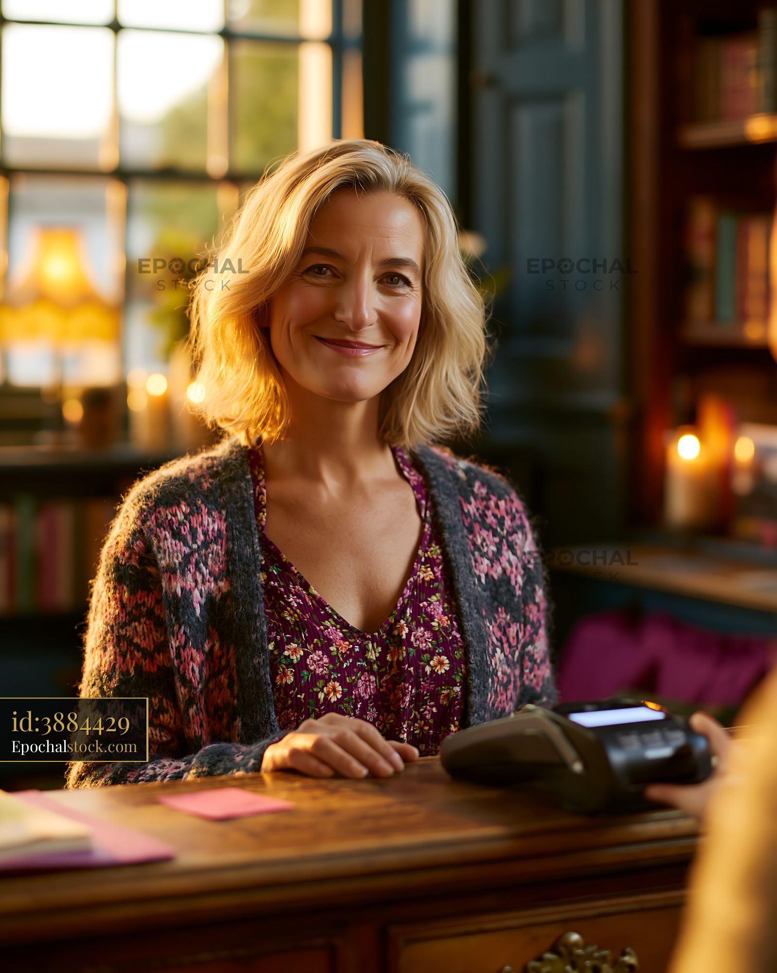 Watermarked full-resolution preview of Woman smiling at a checkout counter in a cozy shop