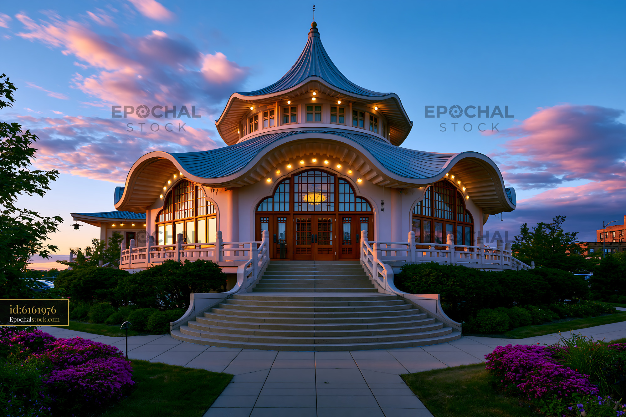Watermarked full-resolution preview of Unique building with curved roof and lights at sunset