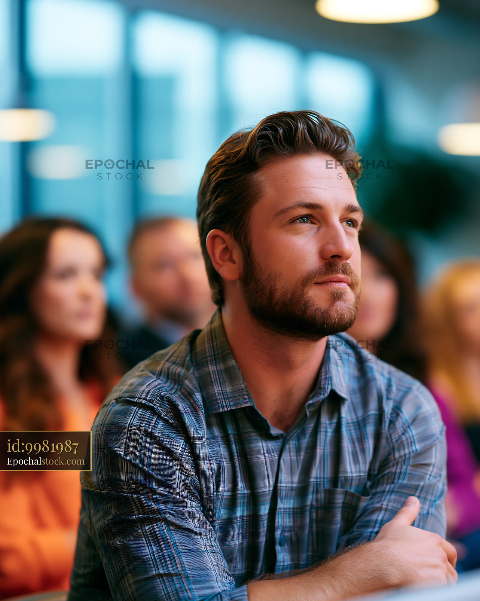 Watermarked full-resolution preview of Man listening attentively in a group setting indoors