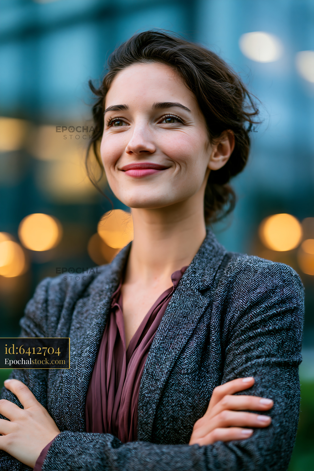 Watermarked full-resolution preview of Confident woman smiling outdoors in a city setting