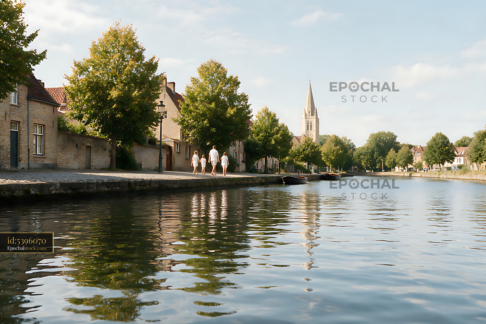 Watermarked full-resolution preview of Family walking along a picturesque canal toward church