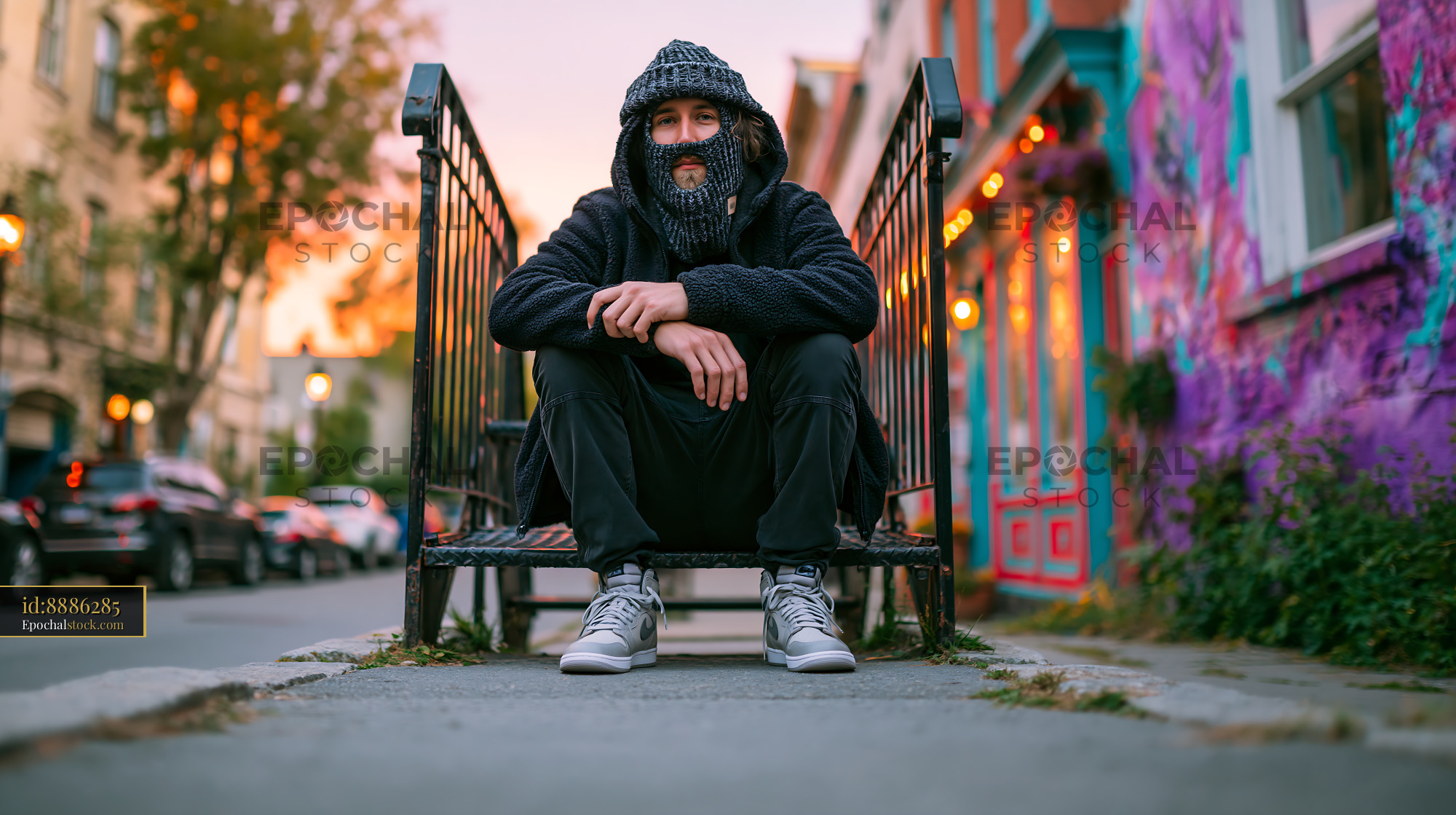 Watermarked full-resolution preview of Man on a metal railing in a colorful urban area