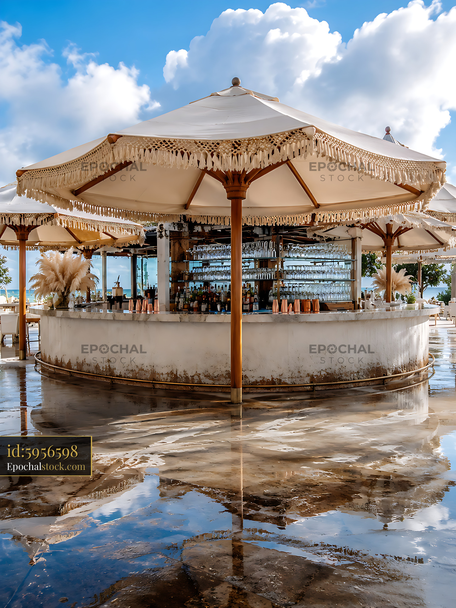 Bar Structure With Thatched Canopy Reflects in Water at Resort - stock photo