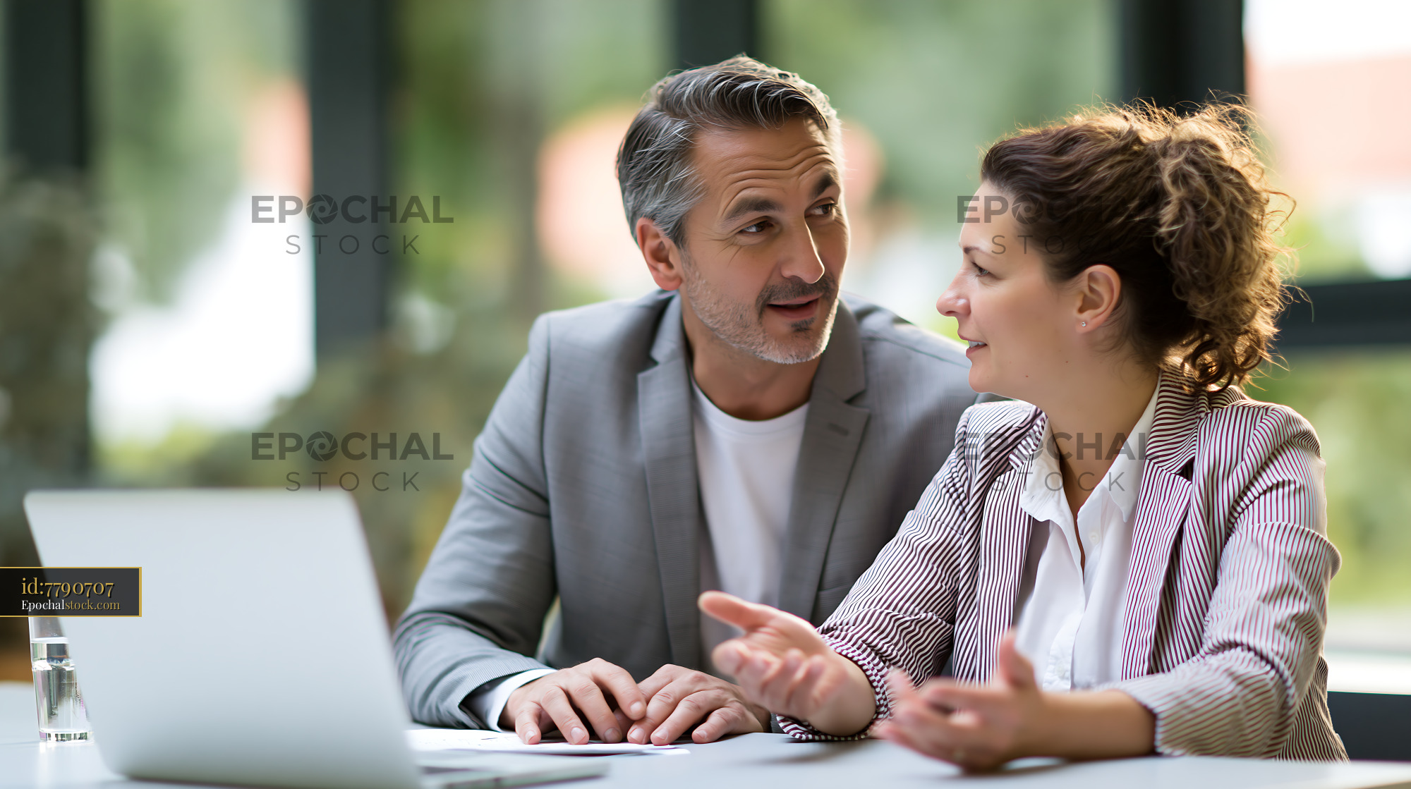 Watermarked full-resolution preview of Business meeting between colleagues in modern office