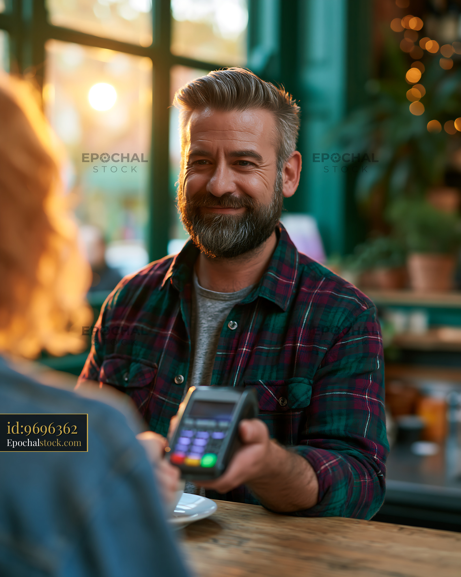Tax Consultant Working With Client in Coffee Shop During Sunset - stock photo
