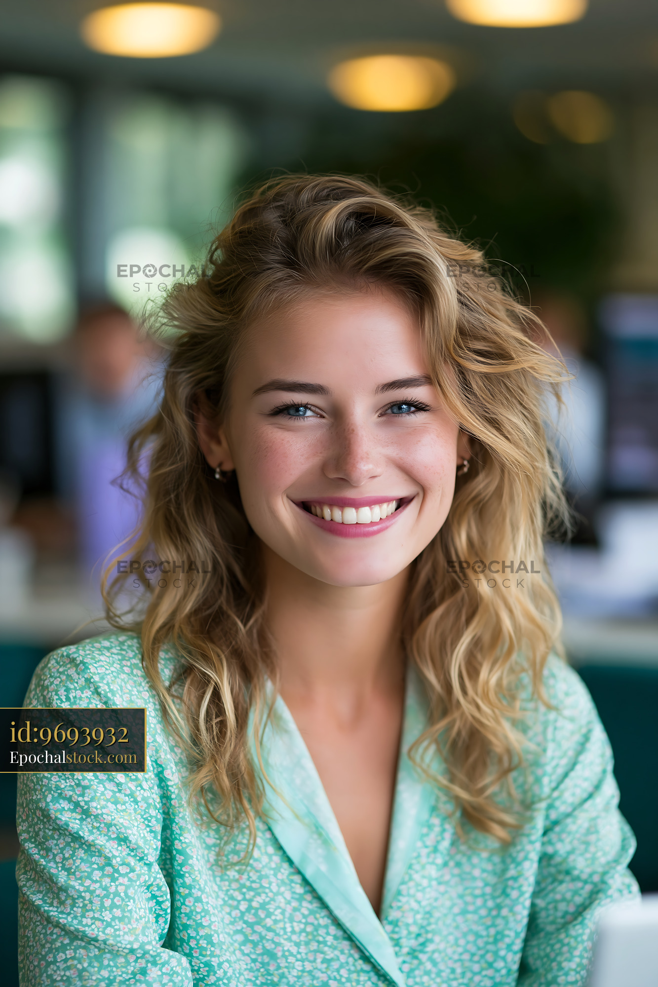 Watermarked full-resolution preview of Smiling woman in a modern work environment