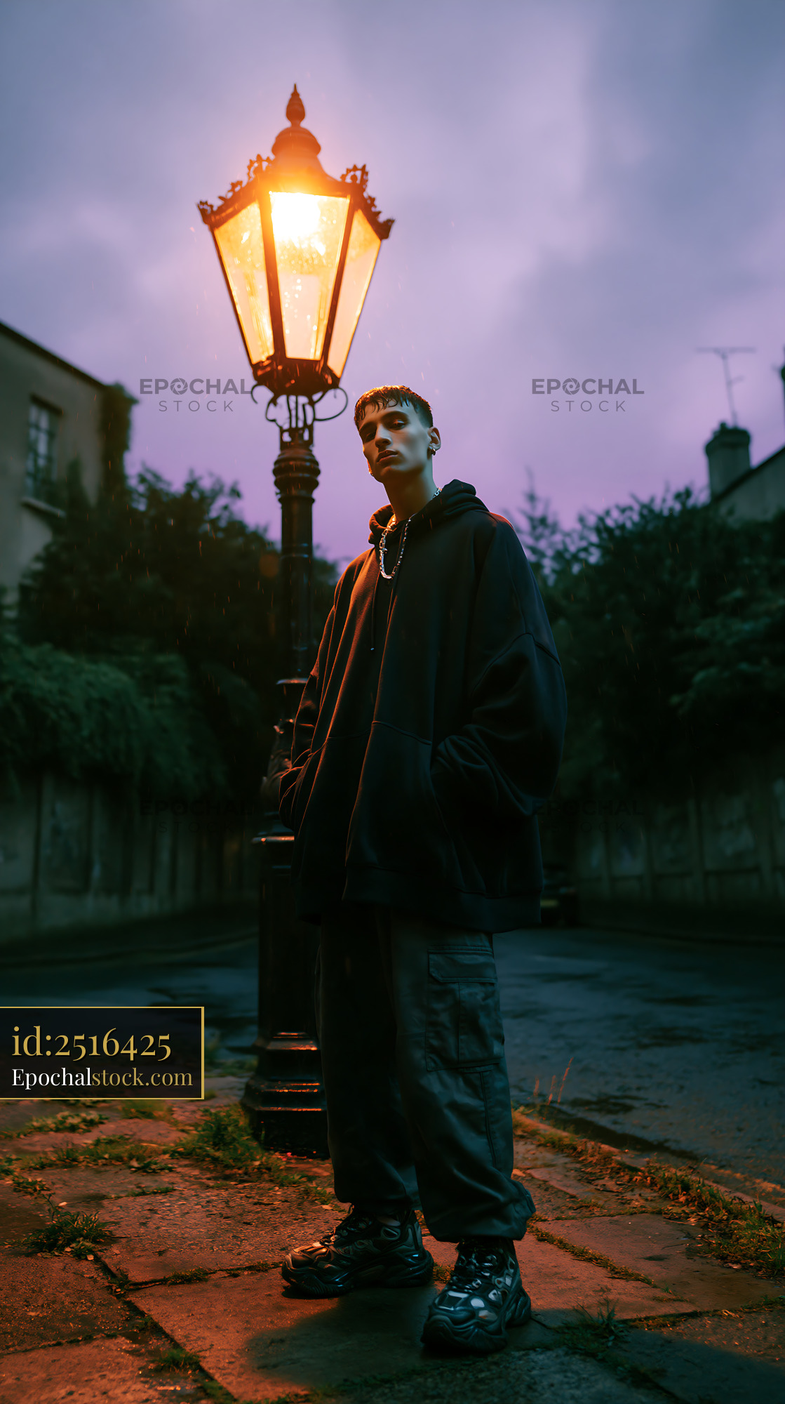 Watermarked full-resolution preview of Individual standing under a street lamp at dusk in a city