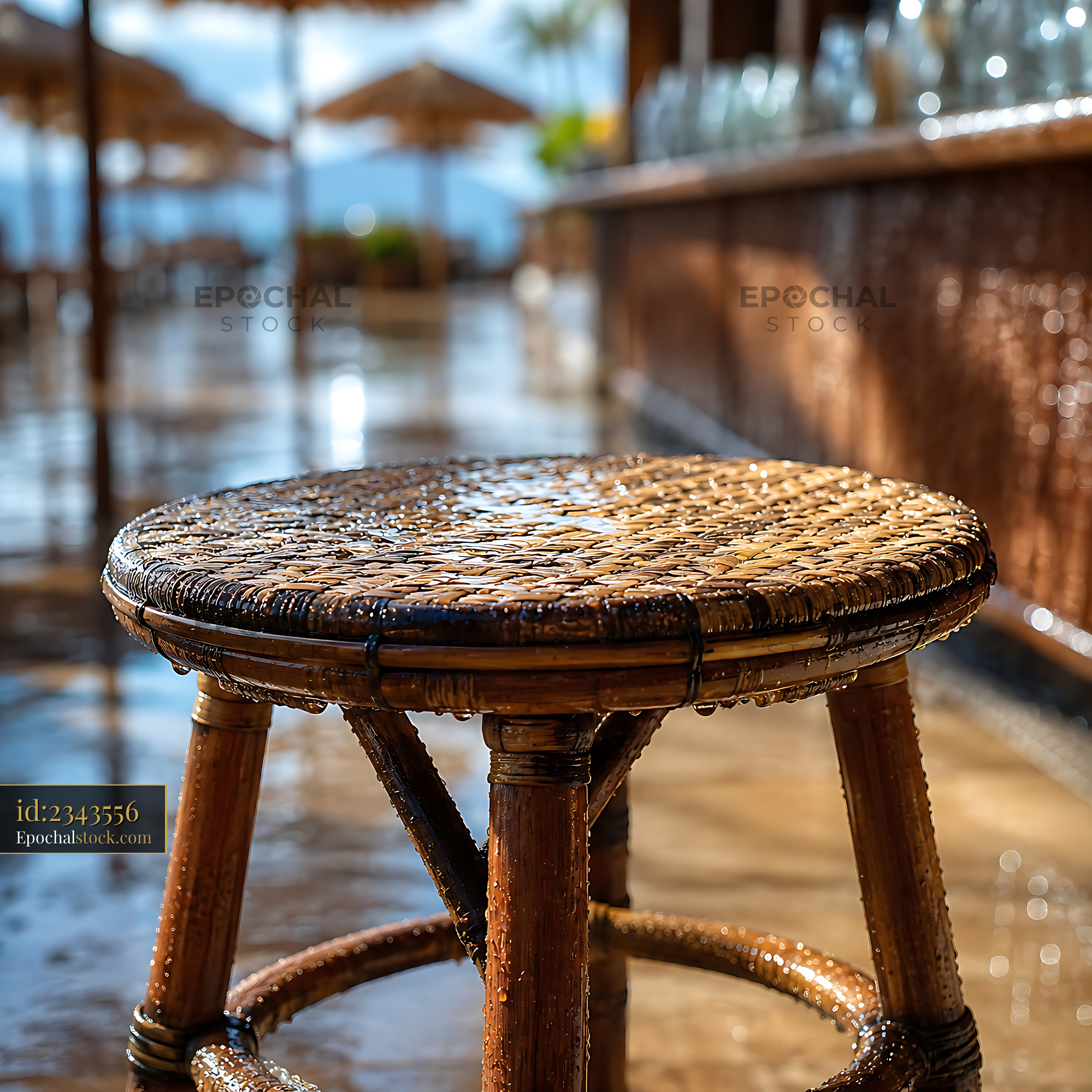 Watermarked full-resolution preview of Wet bamboo stool at a beach bar on a sunny day