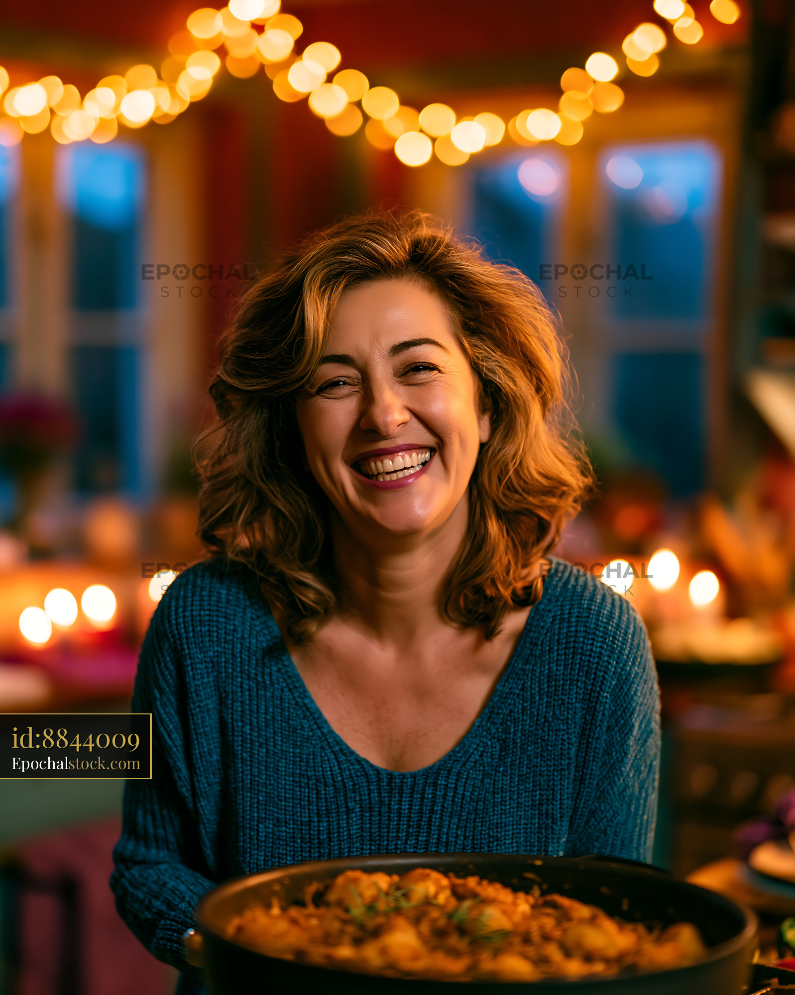 Watermarked full-resolution preview of Woman smiles while holding a pot of food in a cozy kitchen