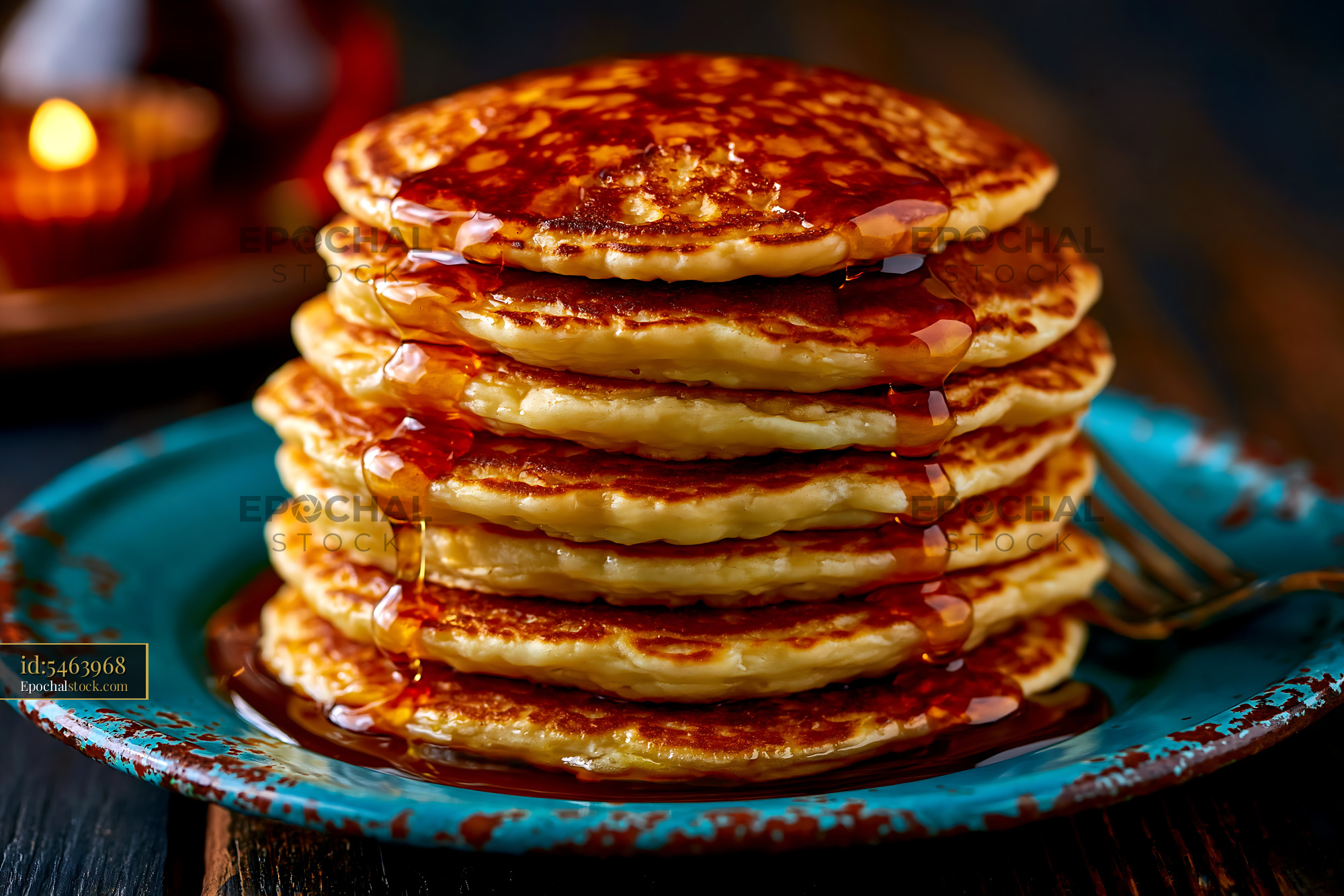 Watermarked full-resolution preview of Stack of pancakes with syrup on blue plate
