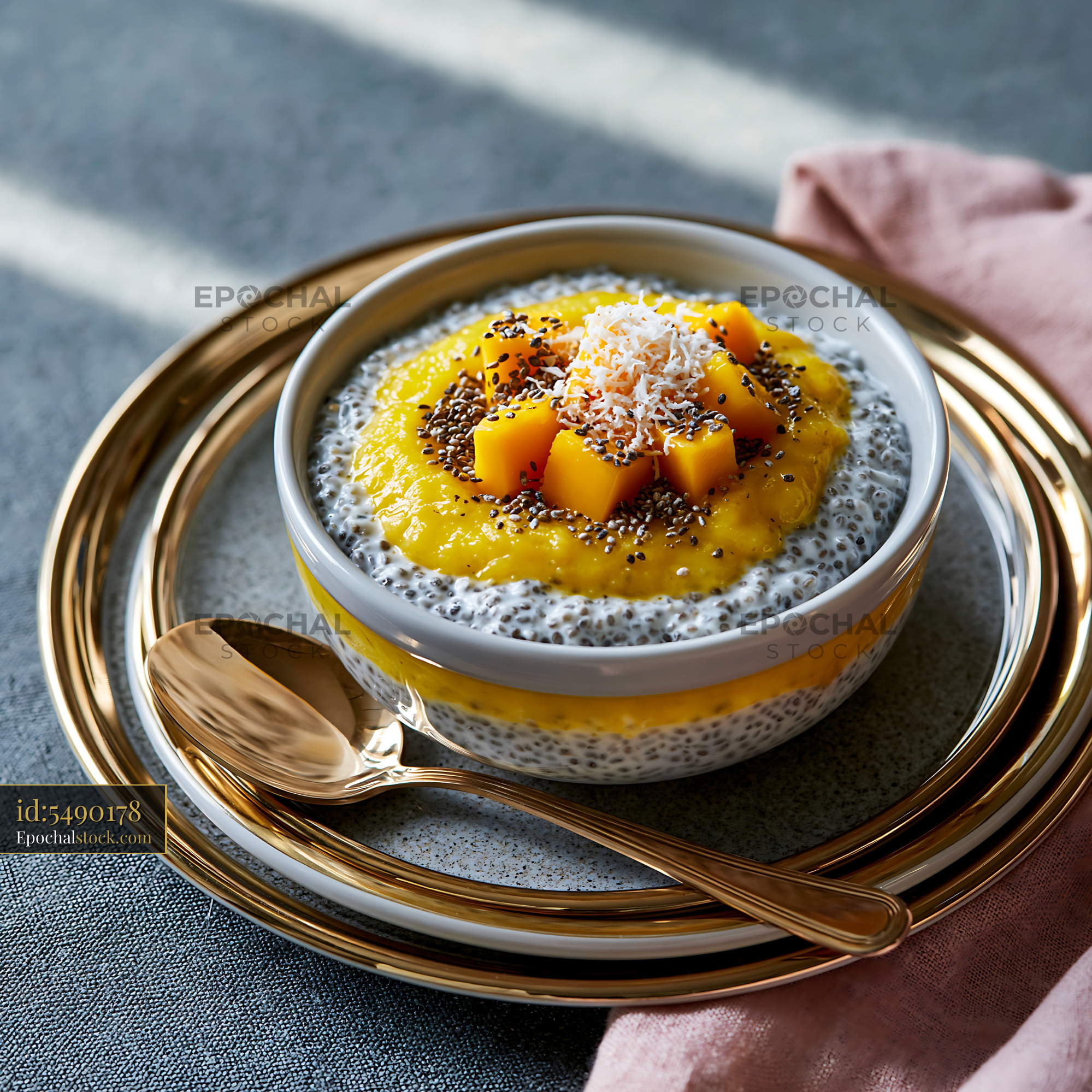 Watermarked full-resolution preview of Chia pudding topped with mango and coconut on a table