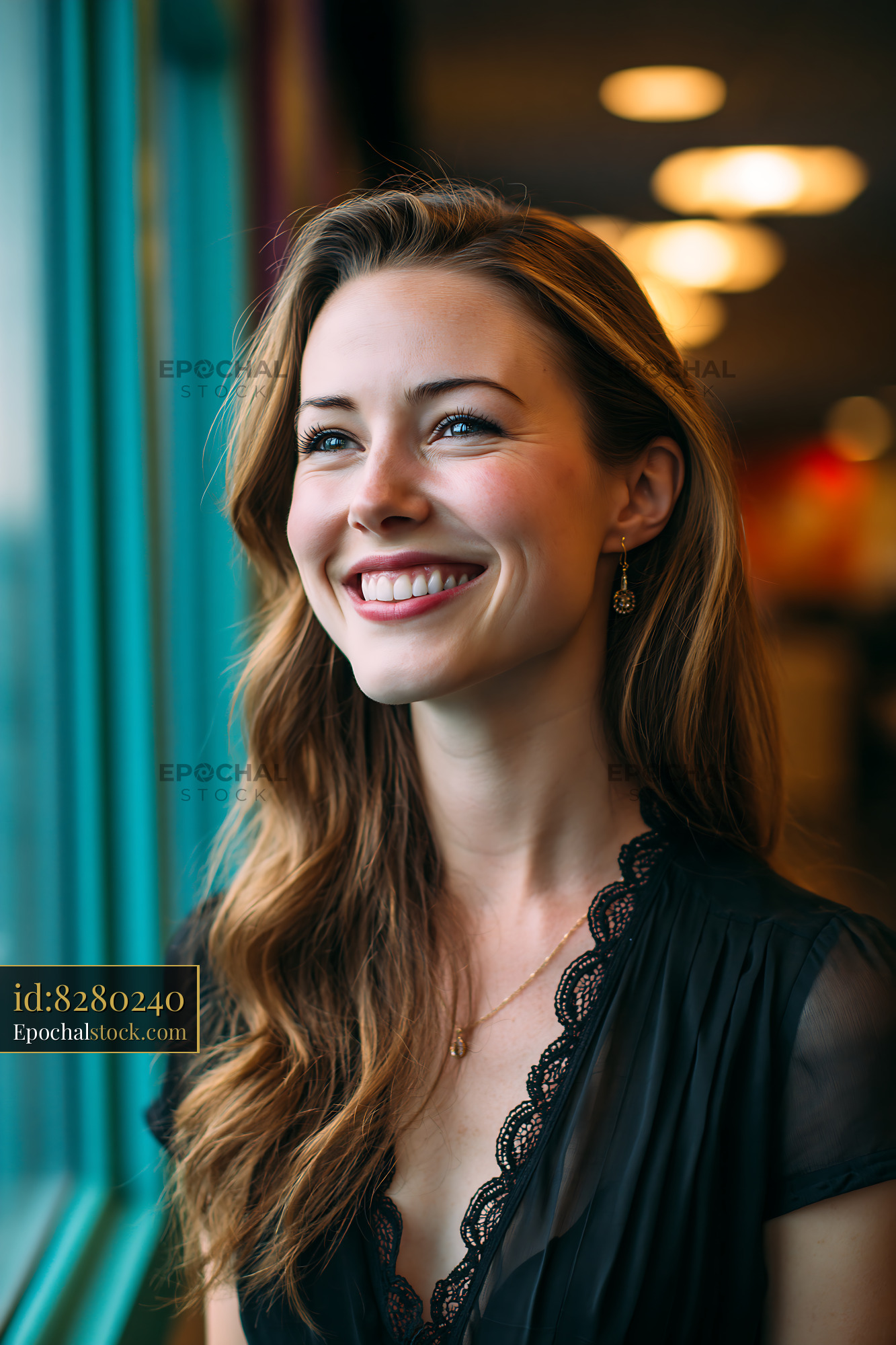 Watermarked full-resolution preview of Woman with long hair smiling near a window