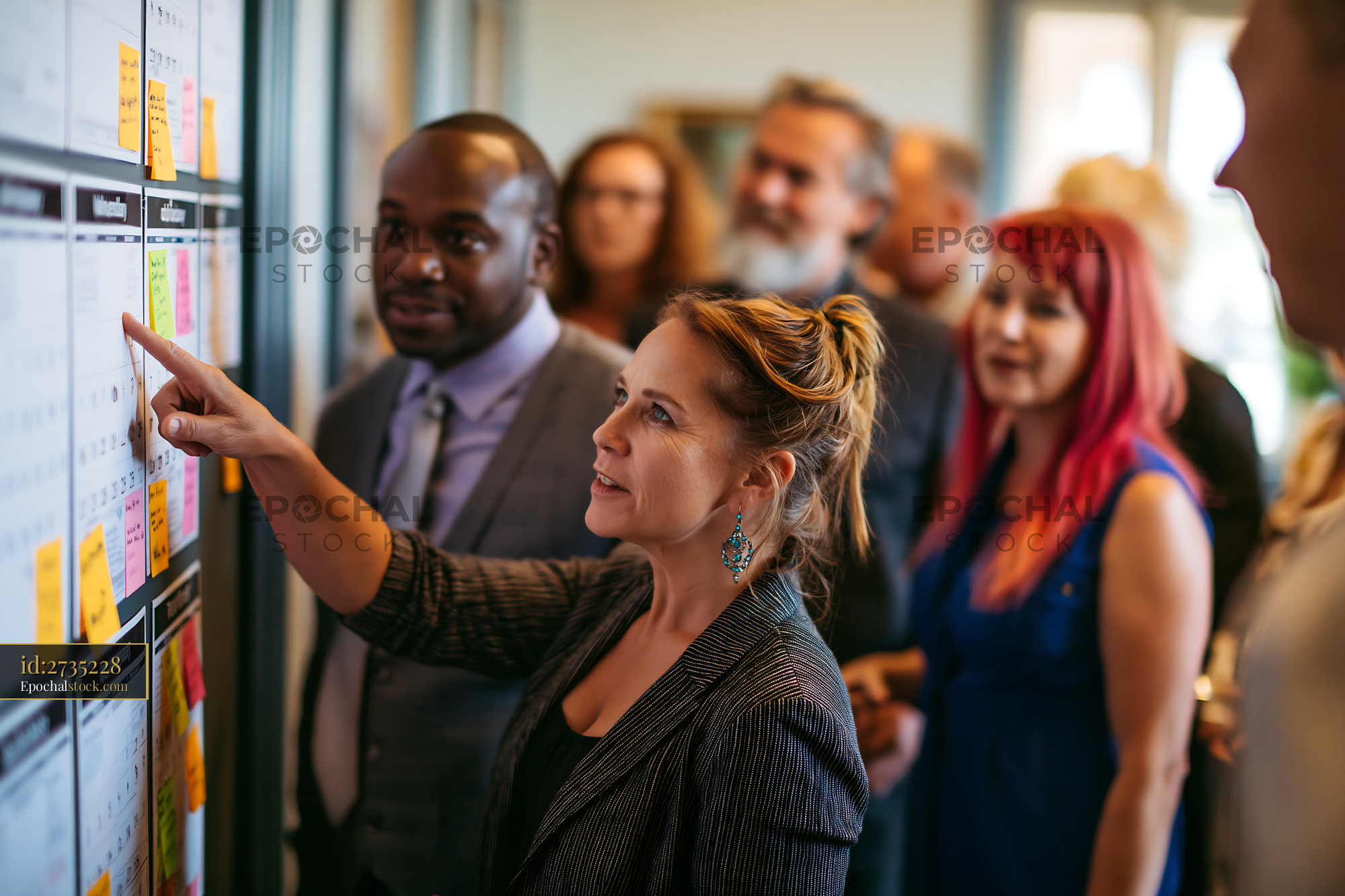 Watermarked full-resolution preview of Group of people discussing ideas in an office environment