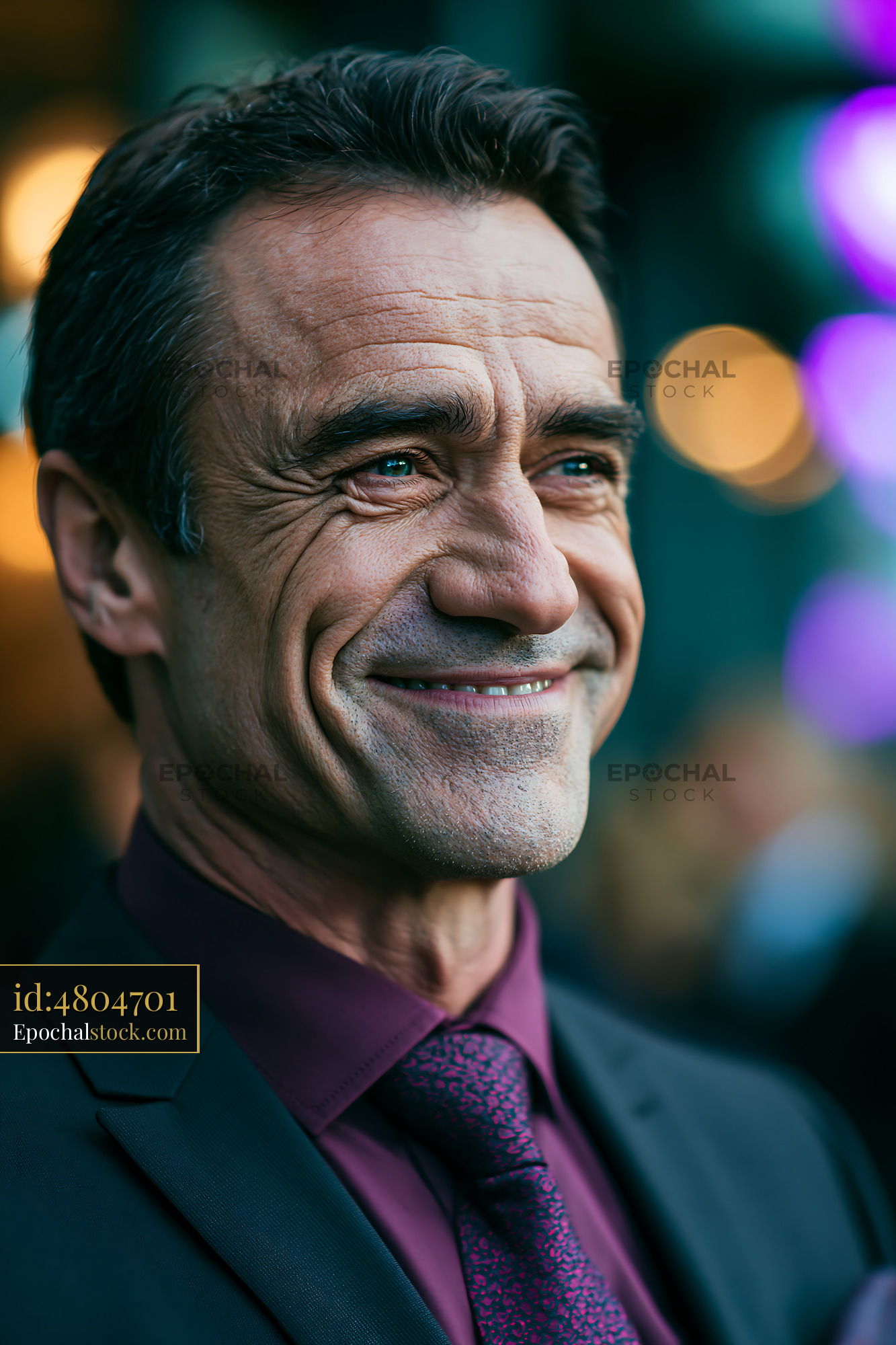 Watermarked full-resolution preview of Man smiling in a formal suit at a social event