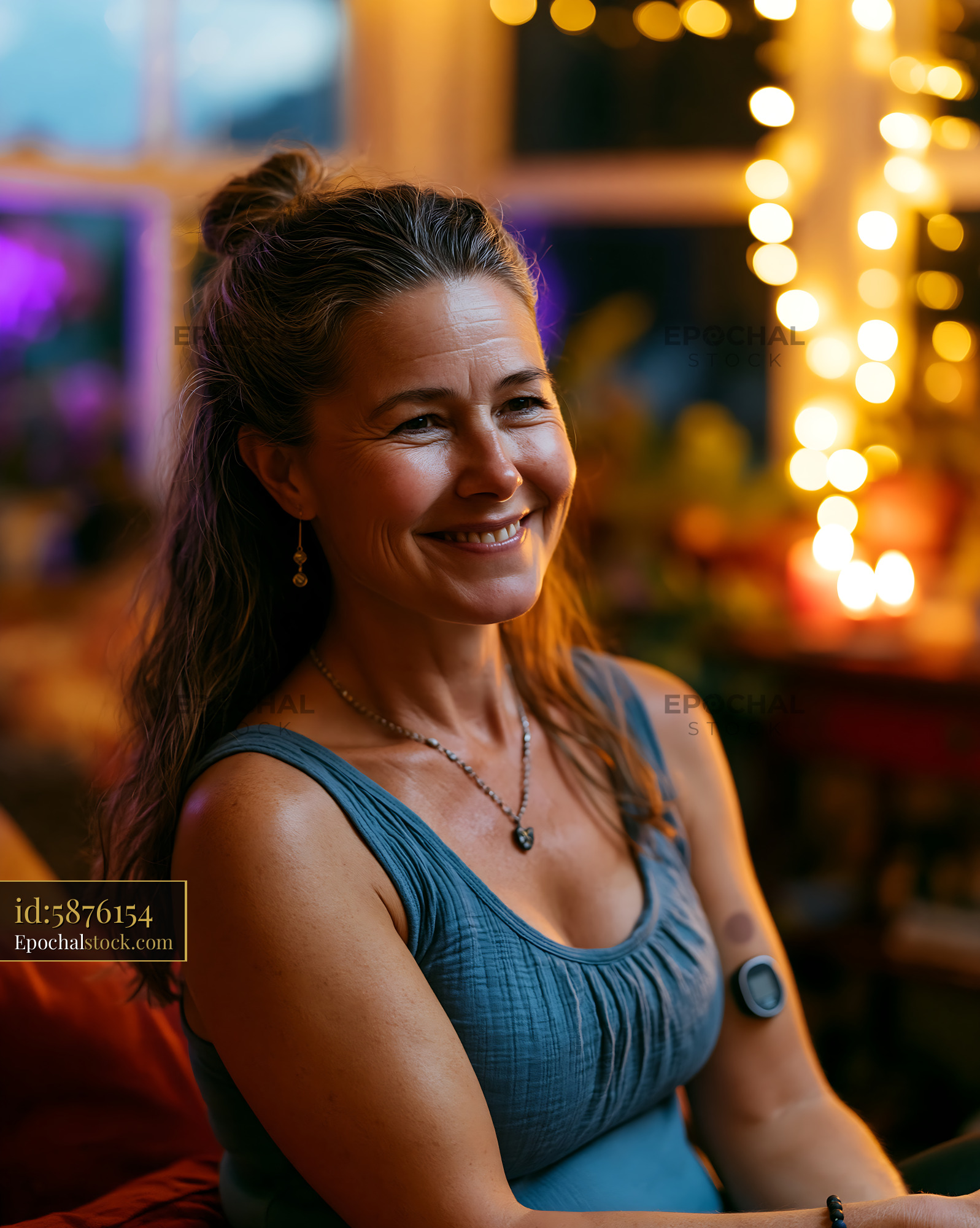 Runner With Glucose Sensor Enjoying Social Setting in Evening - stock photo