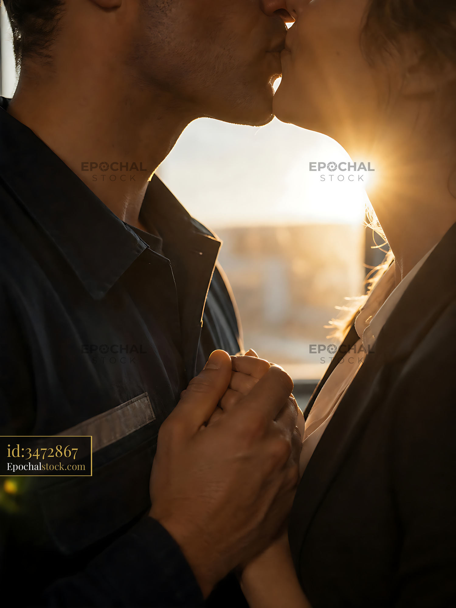 Watermarked full-resolution preview of Couple sharing a kiss during sunset in a cozy setting