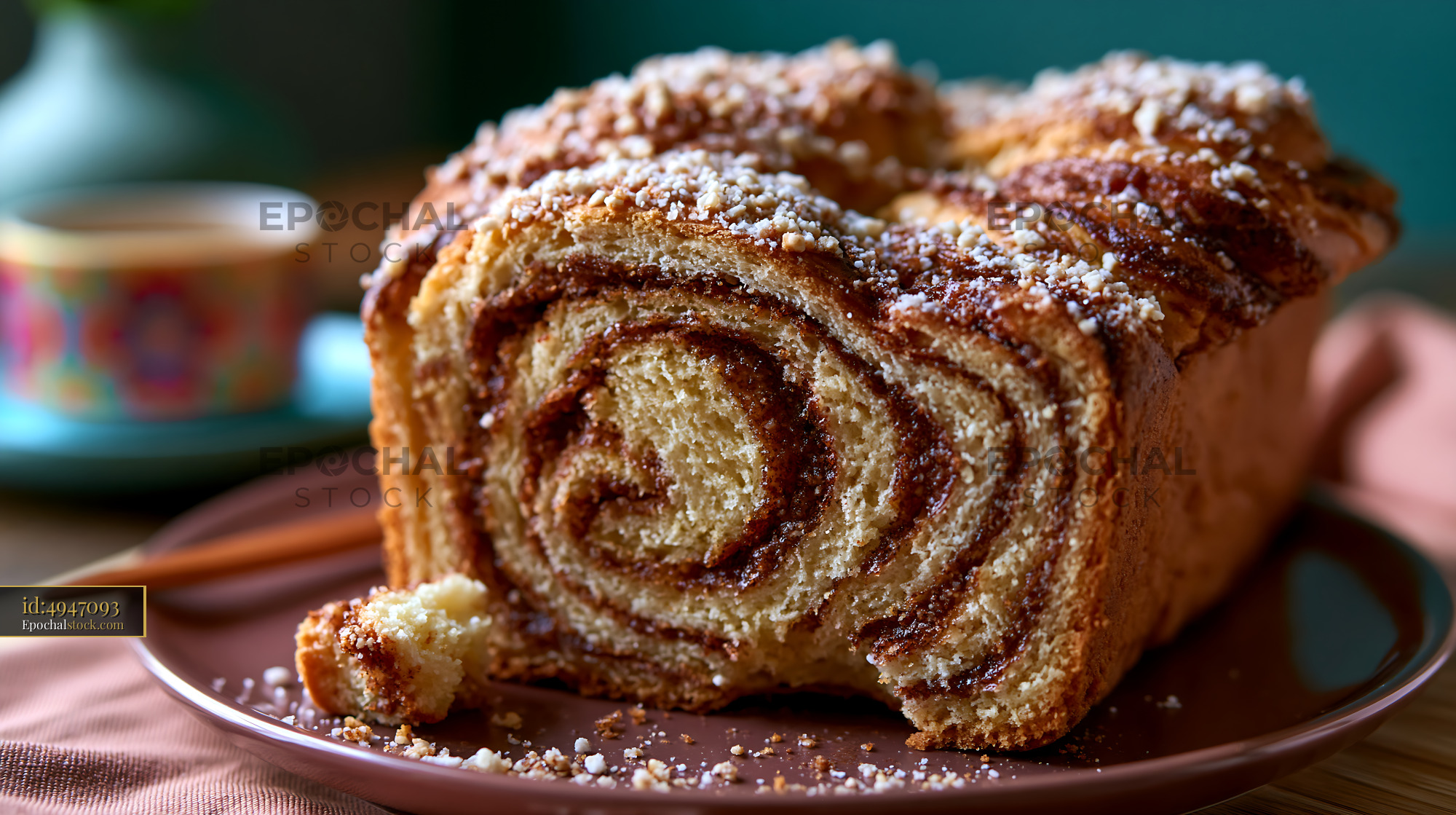 Watermarked full-resolution preview of Freshly baked cinnamon swirl bread on a table with coffee
