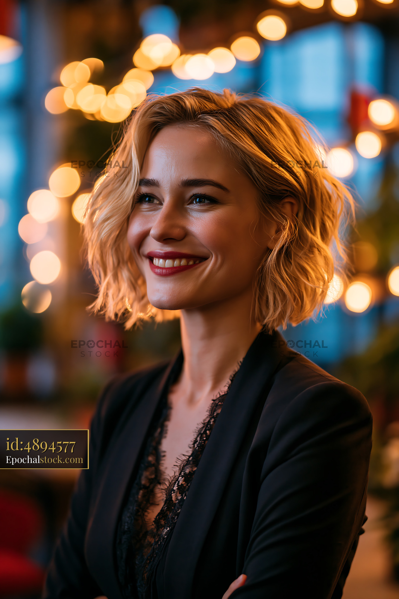 Watermarked full-resolution preview of Woman smiling in a dimly lit cafe with decorative lights
