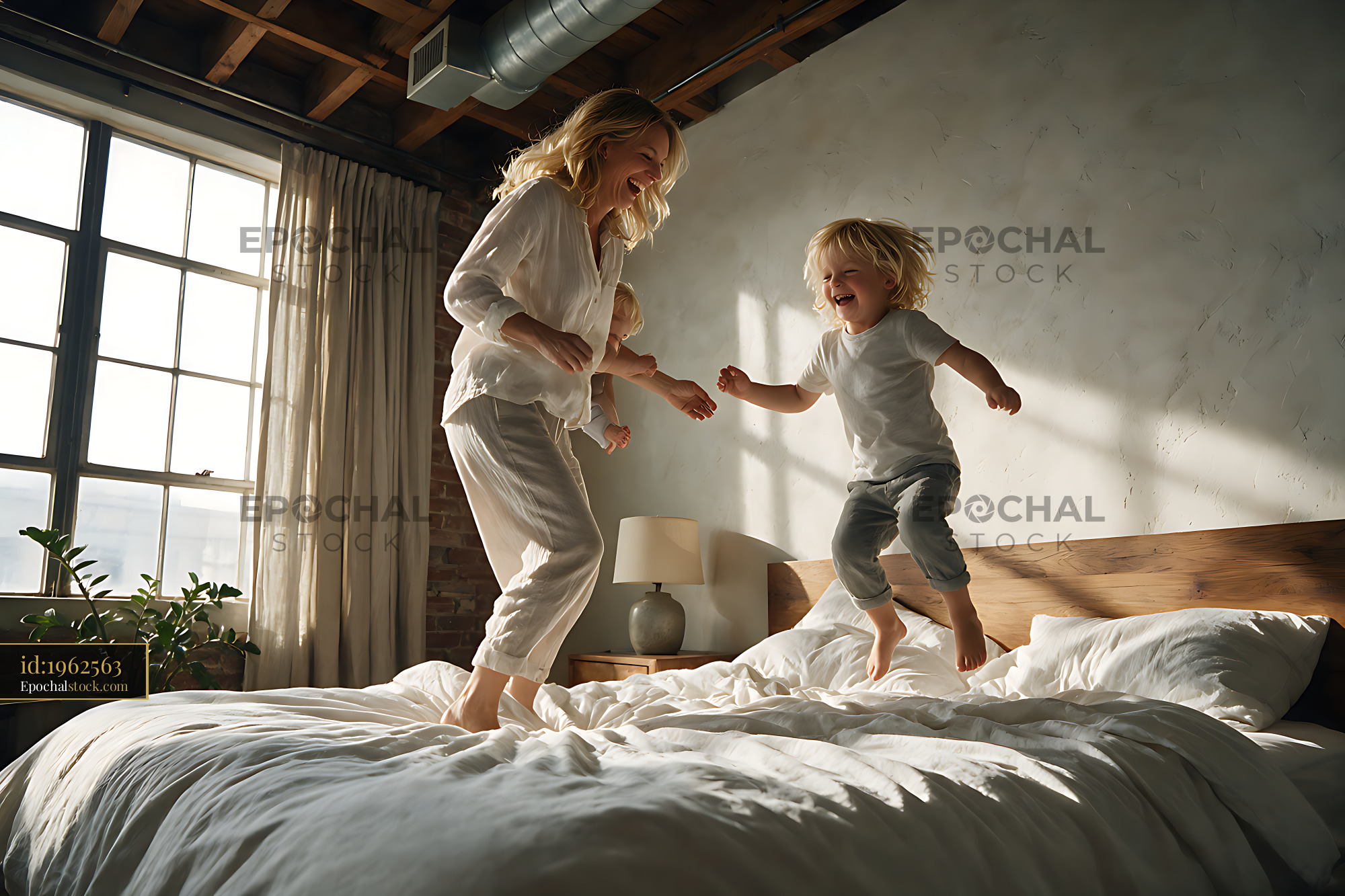 Watermarked full-resolution preview of Mother and children having fun on a bed