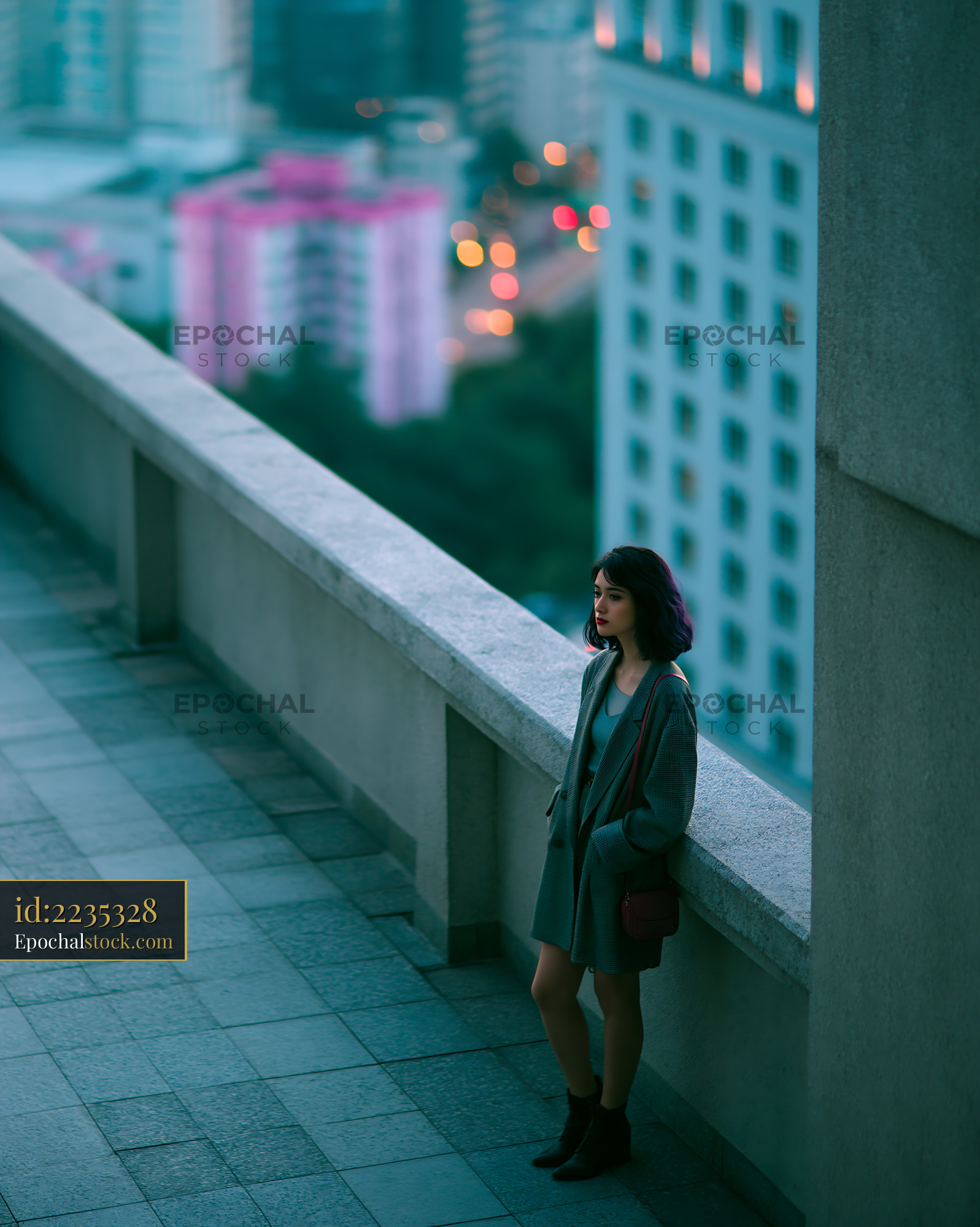 Watermarked full-resolution preview of Woman standing alone on city rooftop during dusk