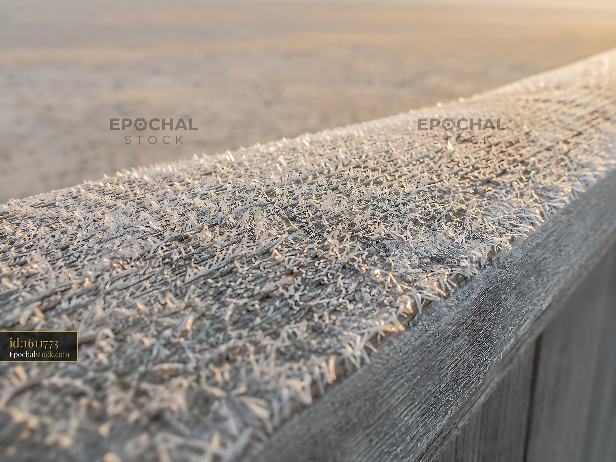 Watermarked full-resolution preview of Frost-covered wooden railing at sunrise on a cold morning
