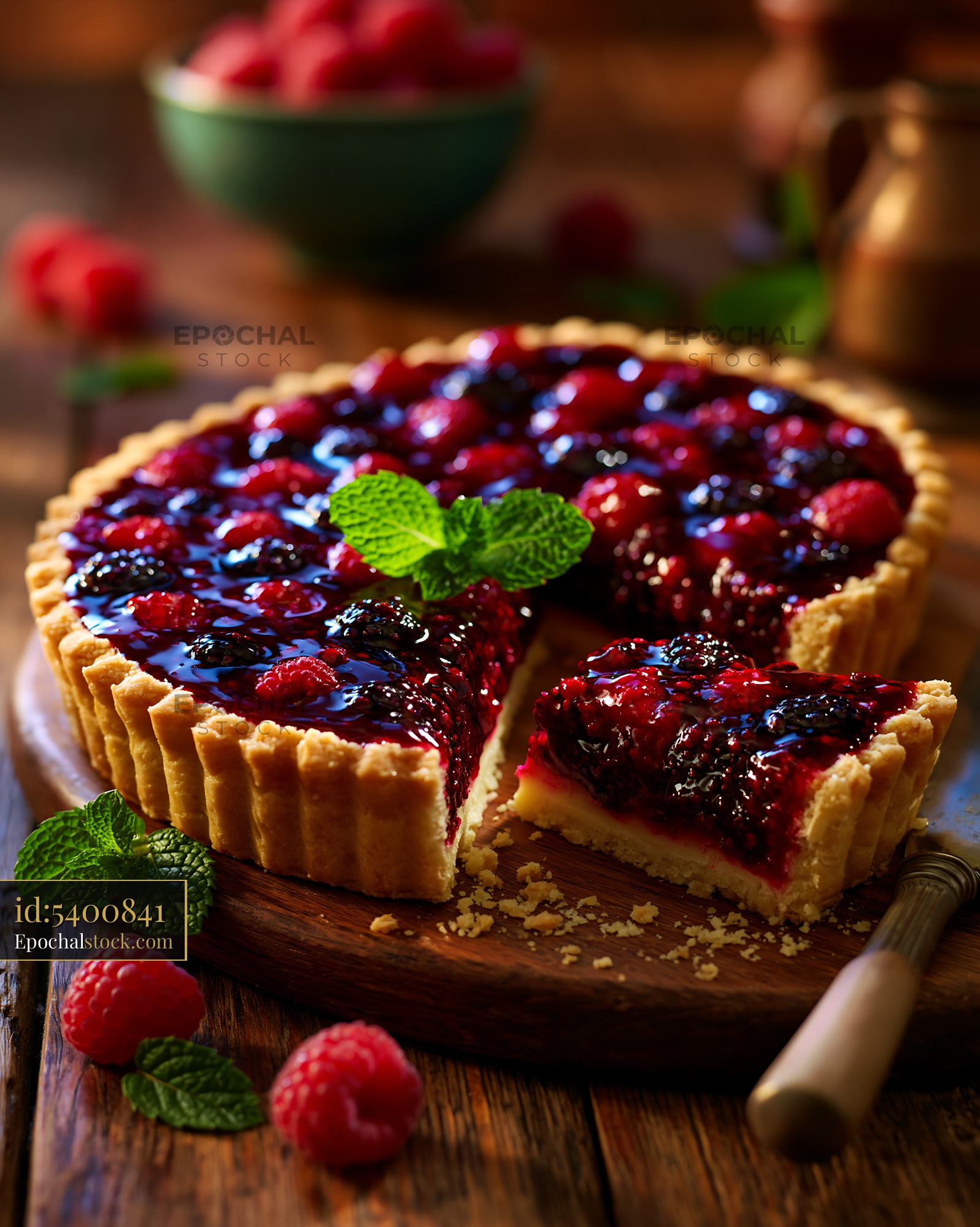 Watermarked full-resolution preview of Fresh berry tart on a wooden table with mint leaves
