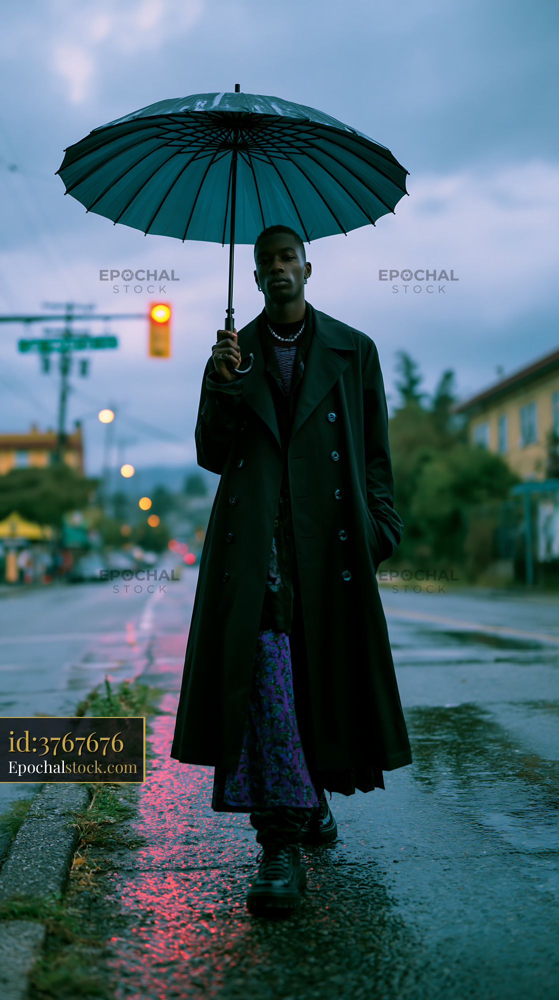Tall Model Holding an Umbrella in a City Street During Evening - stock photo