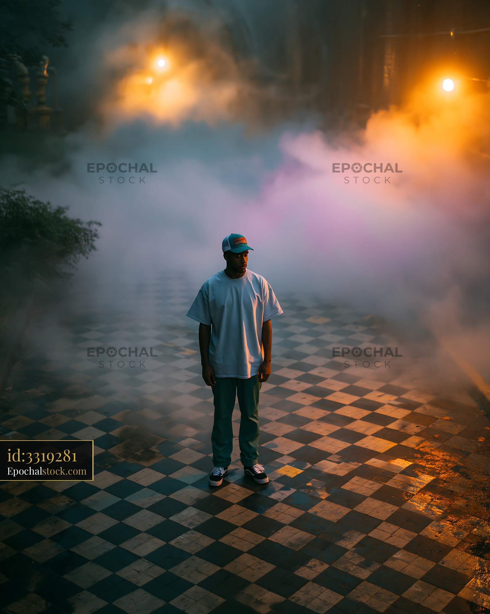 Watermarked full-resolution preview of Man standing on a patterned floor with fog and street lights around