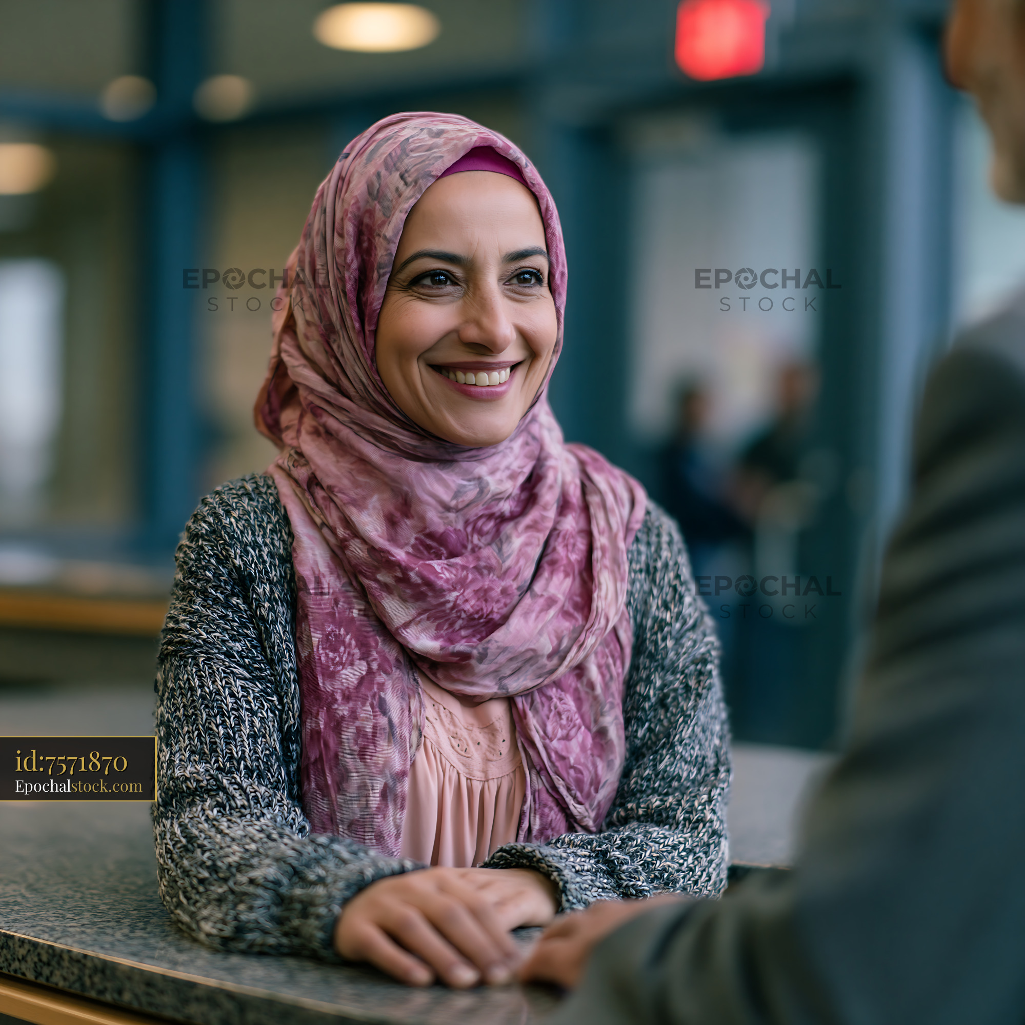 Female Engineer in Hijab Greeting Customer at Office Setting — stock example for comparison and decision framing