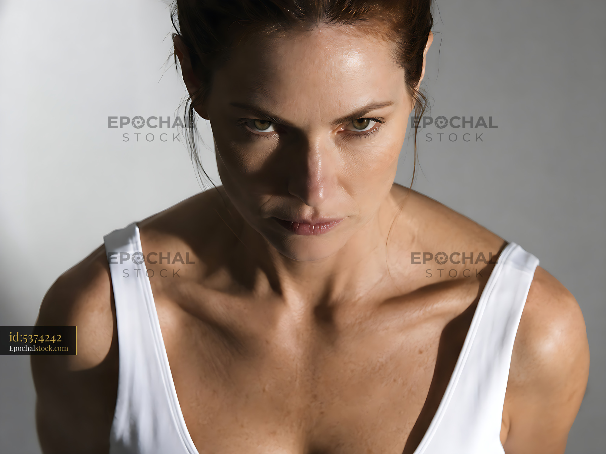 Watermarked full-resolution preview of Woman in a white top looking seriously at the camera