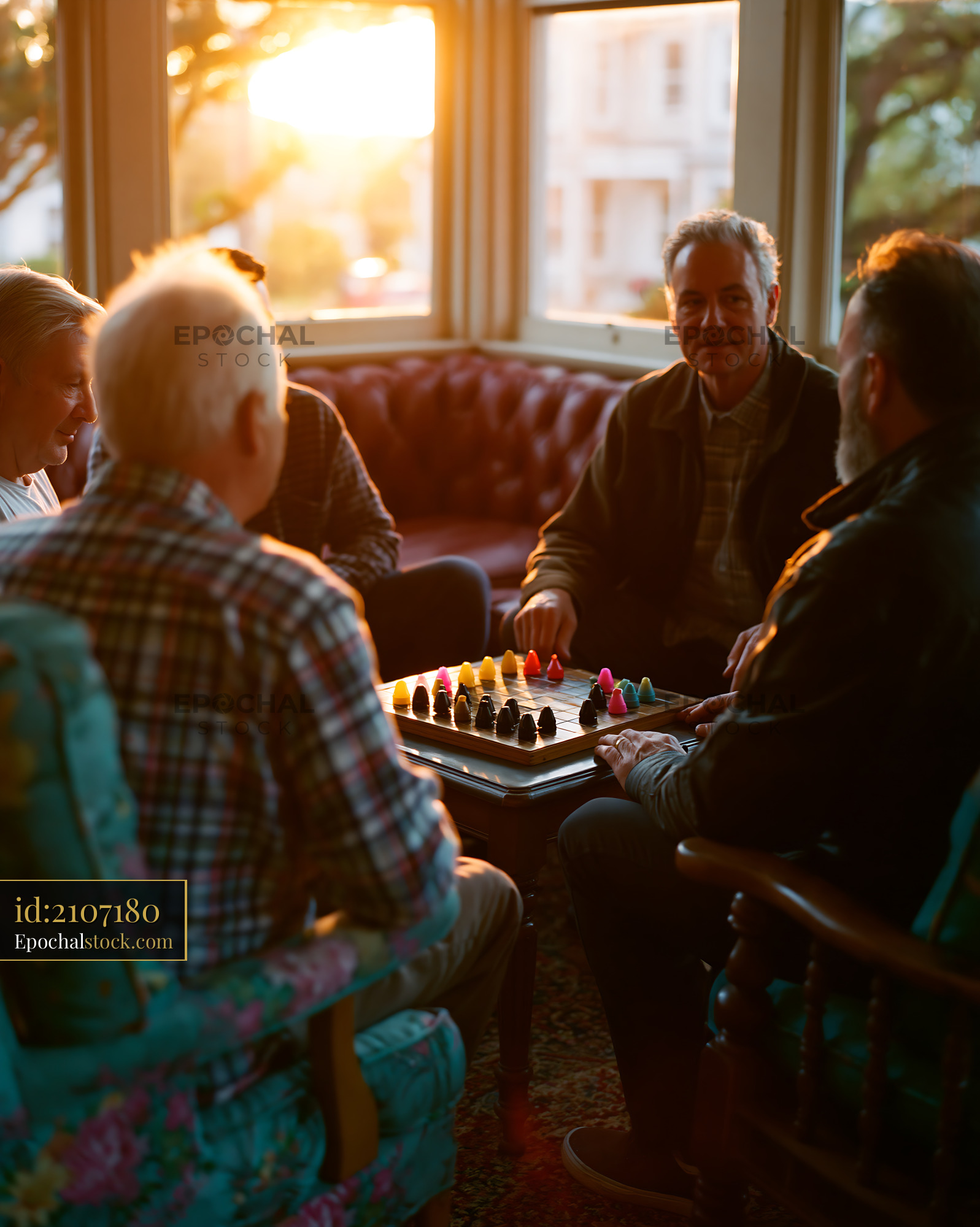 Watermarked full-resolution preview of People playing a game together in a cozy room at sunset