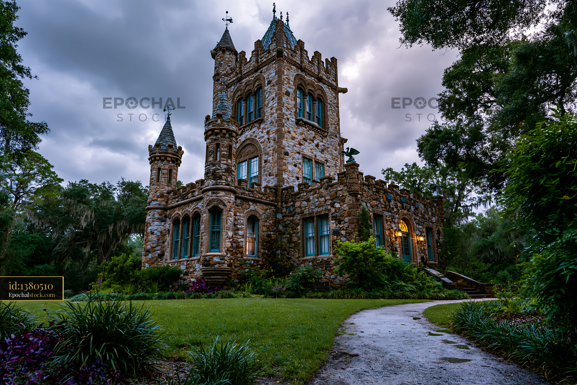 Watermarked full-resolution preview of Historic stone castle surrounded by trees in evening light