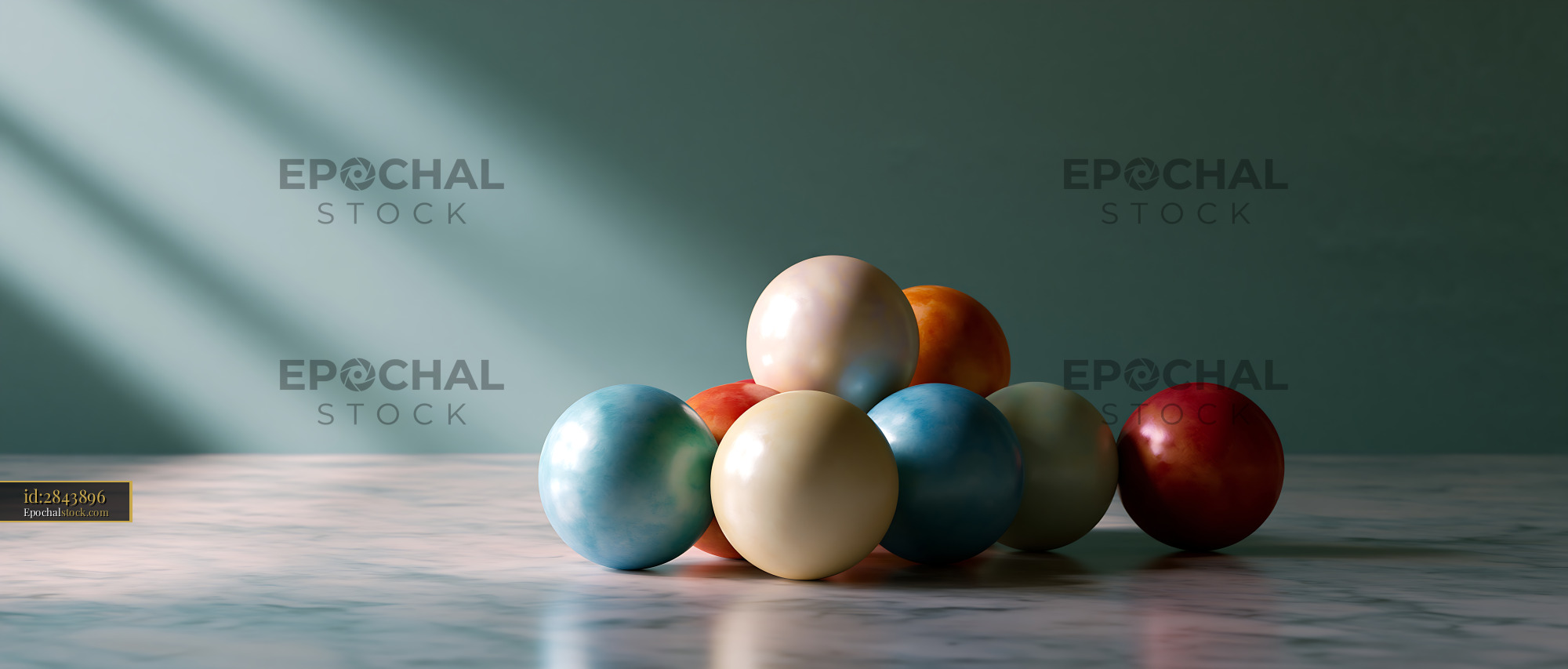 Watermarked full-resolution preview of Colored wooden balls stacked on a marble surface in soft light