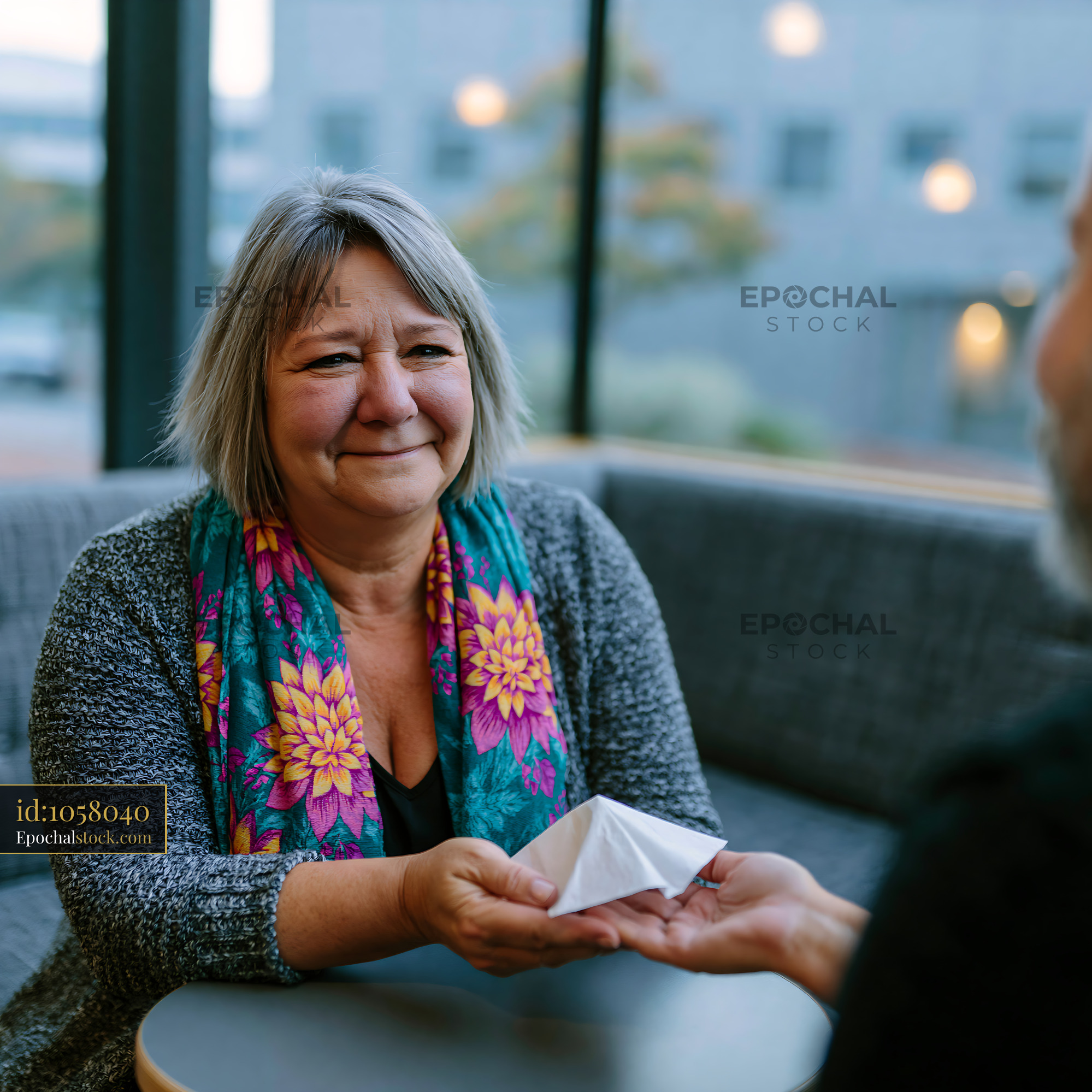 Watermarked full-resolution preview of Woman hands origami to a man in a cafe