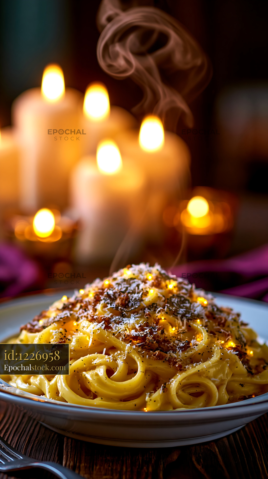 Watermarked full-resolution preview of Warm pasta dish with candles in background