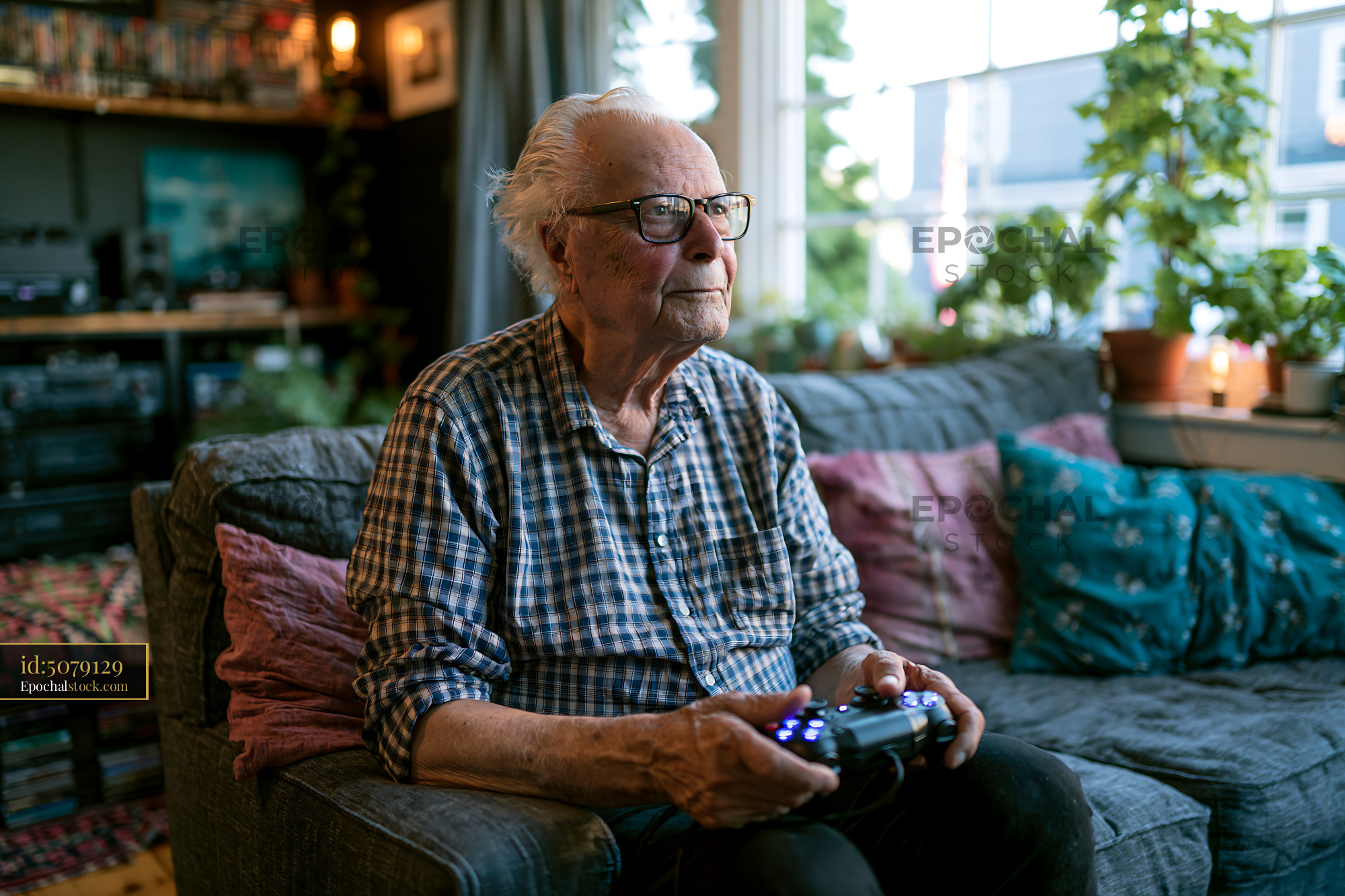 Watermarked full-resolution preview of Elderly man playing video games in a cozy living room