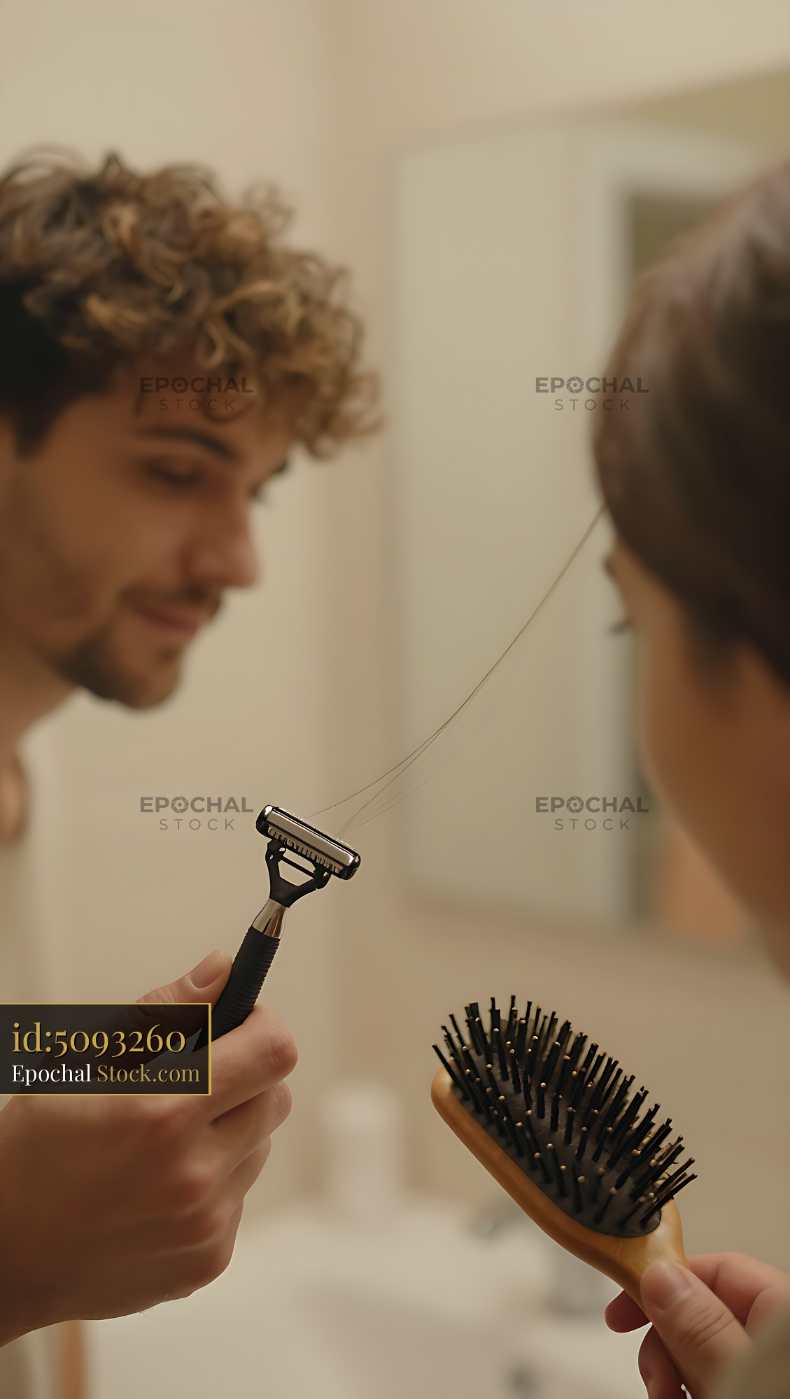 Young man with curly hair shaving with razor and brush in bathroom mir - stock photo