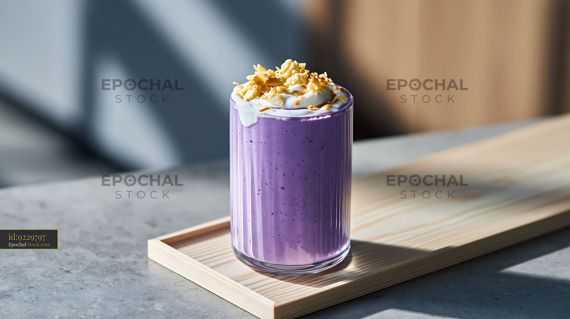 Creamy purple sweet potato smoothie topped with cream on a wooden tray - stock photo
