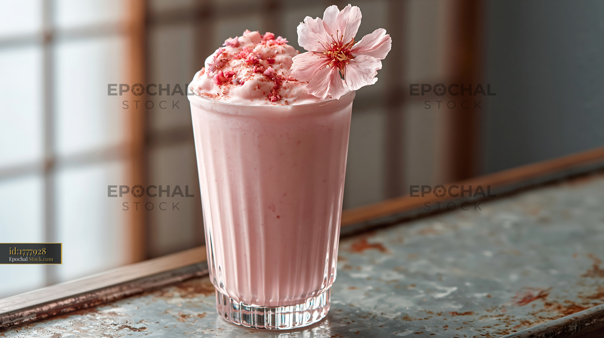 Pink sakura blossom smoothie topped with fresh cherry flower - stock photo