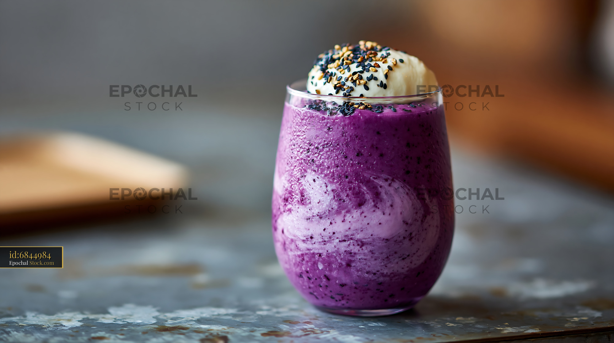Vibrant purple beni imo smoothie topped with cream and sesame seeds - stock photo