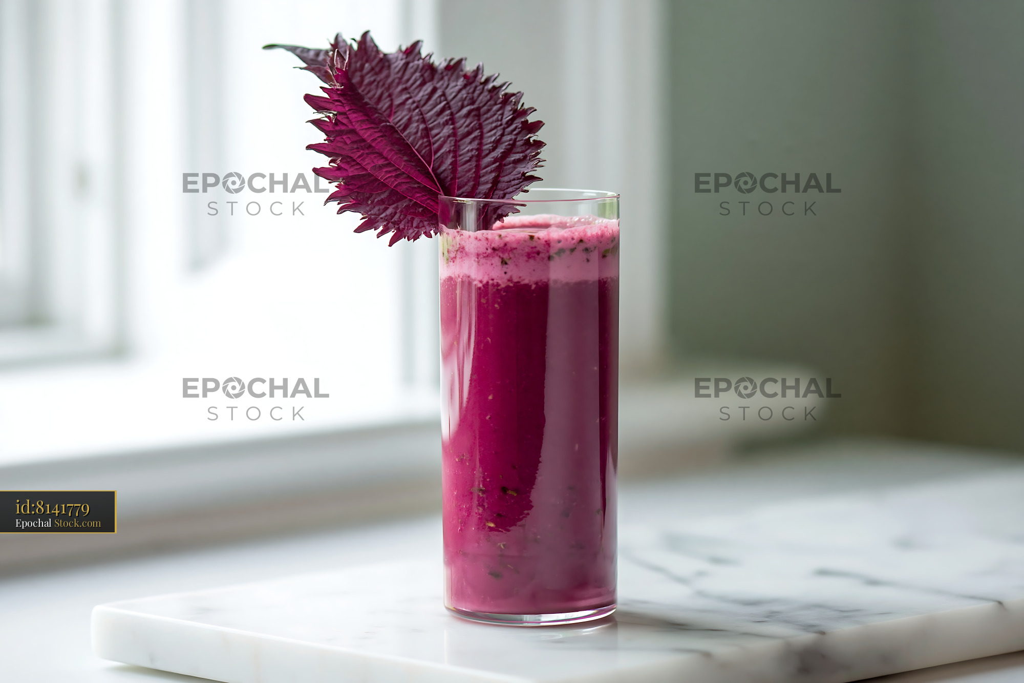 Purple shiso leaf smoothie in a glass on a marble surface - stock photo