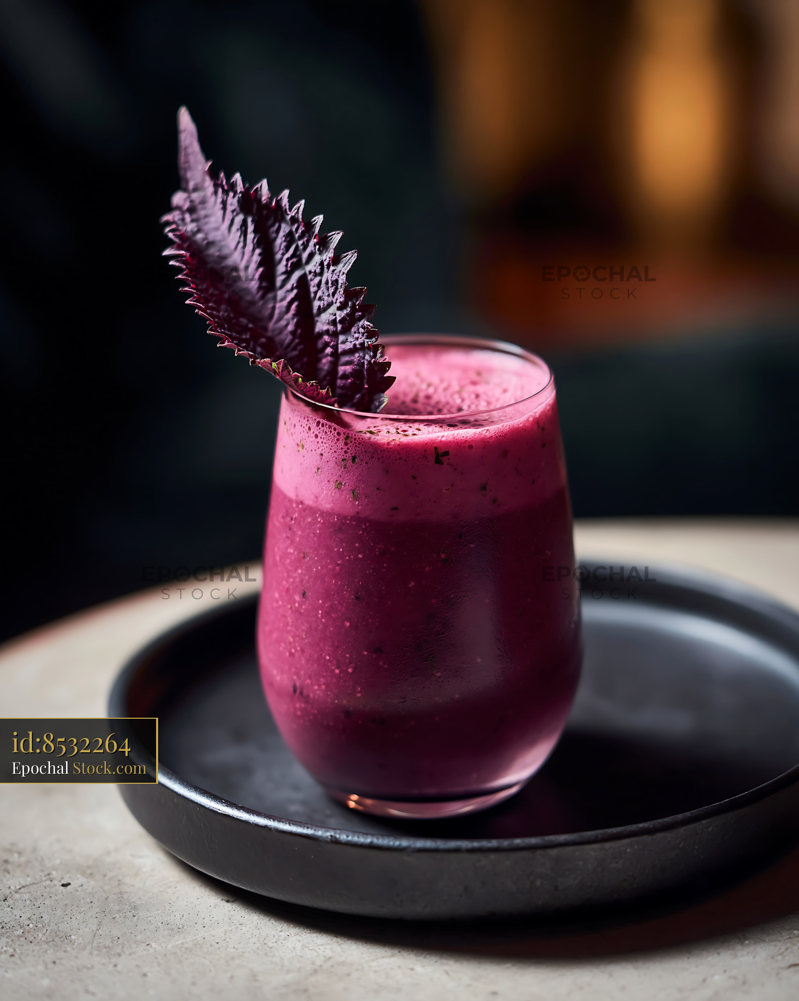 Vibrant purple shiso leaf smoothie in a glass with perilla garnish - stock photo