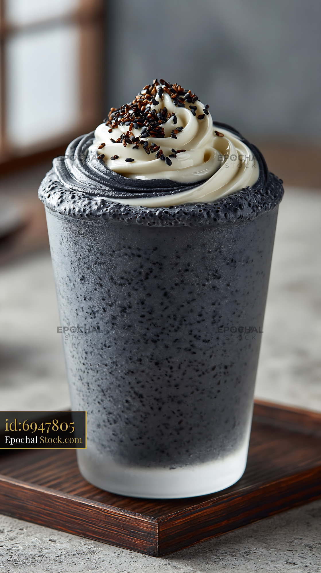 Creamy kurogoma smoothie topped with sesame whipped cream and seeds - stock photo