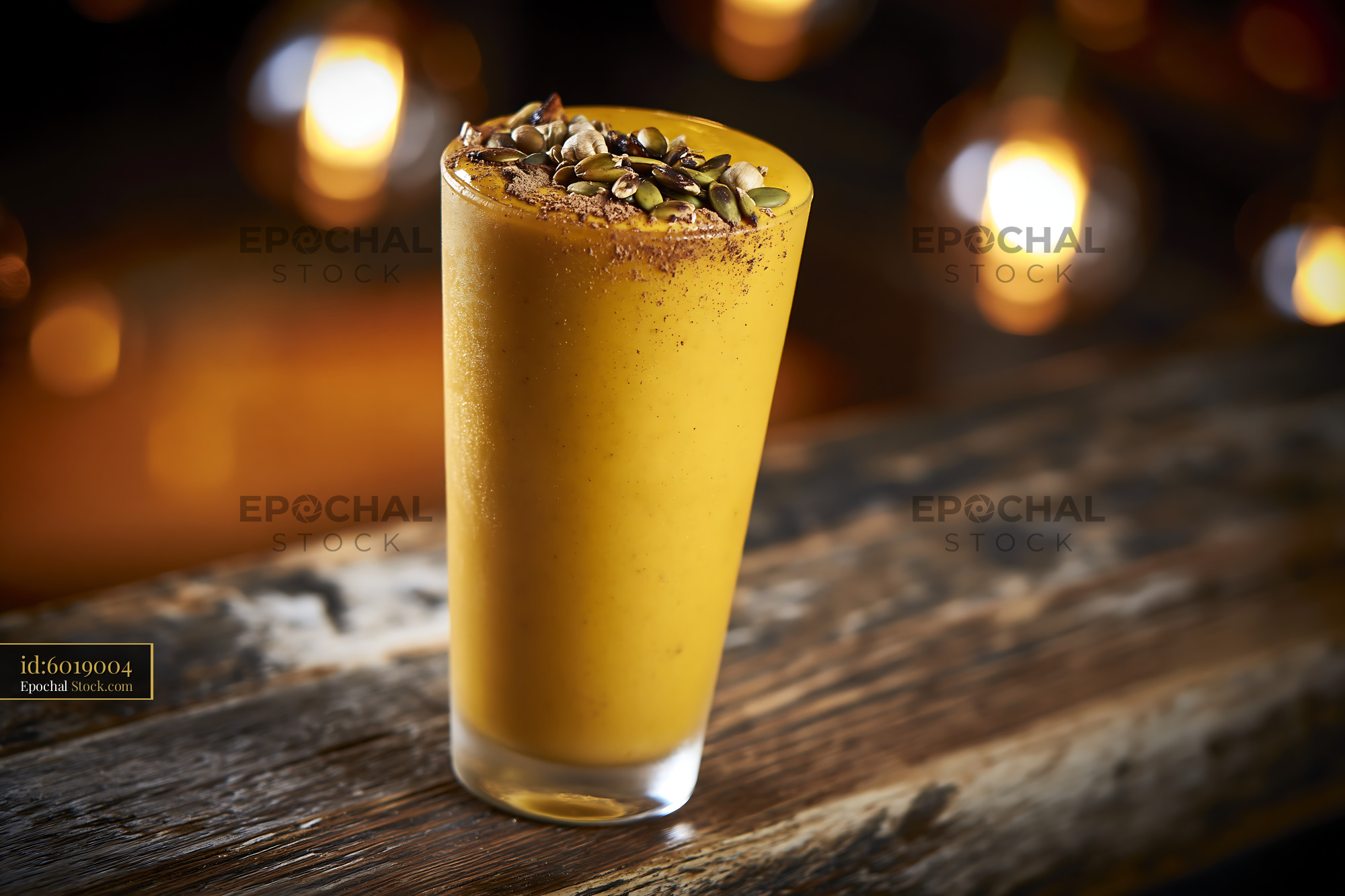Creamy kabocha pumpkin smoothie with seeds on a rustic wooden table - stock photo