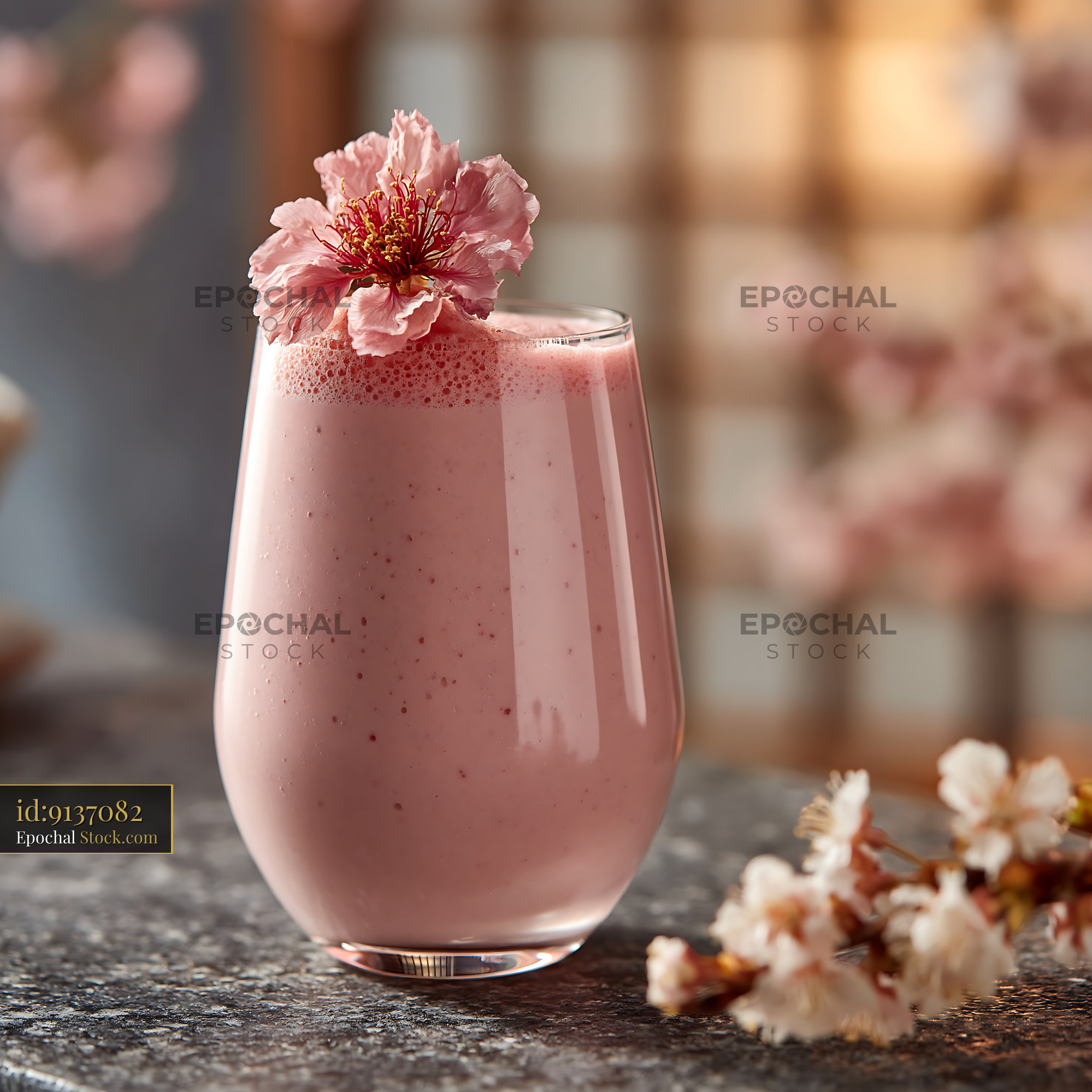Sakura blossom smoothie in a glass garnished with a pink flower - stock photo
