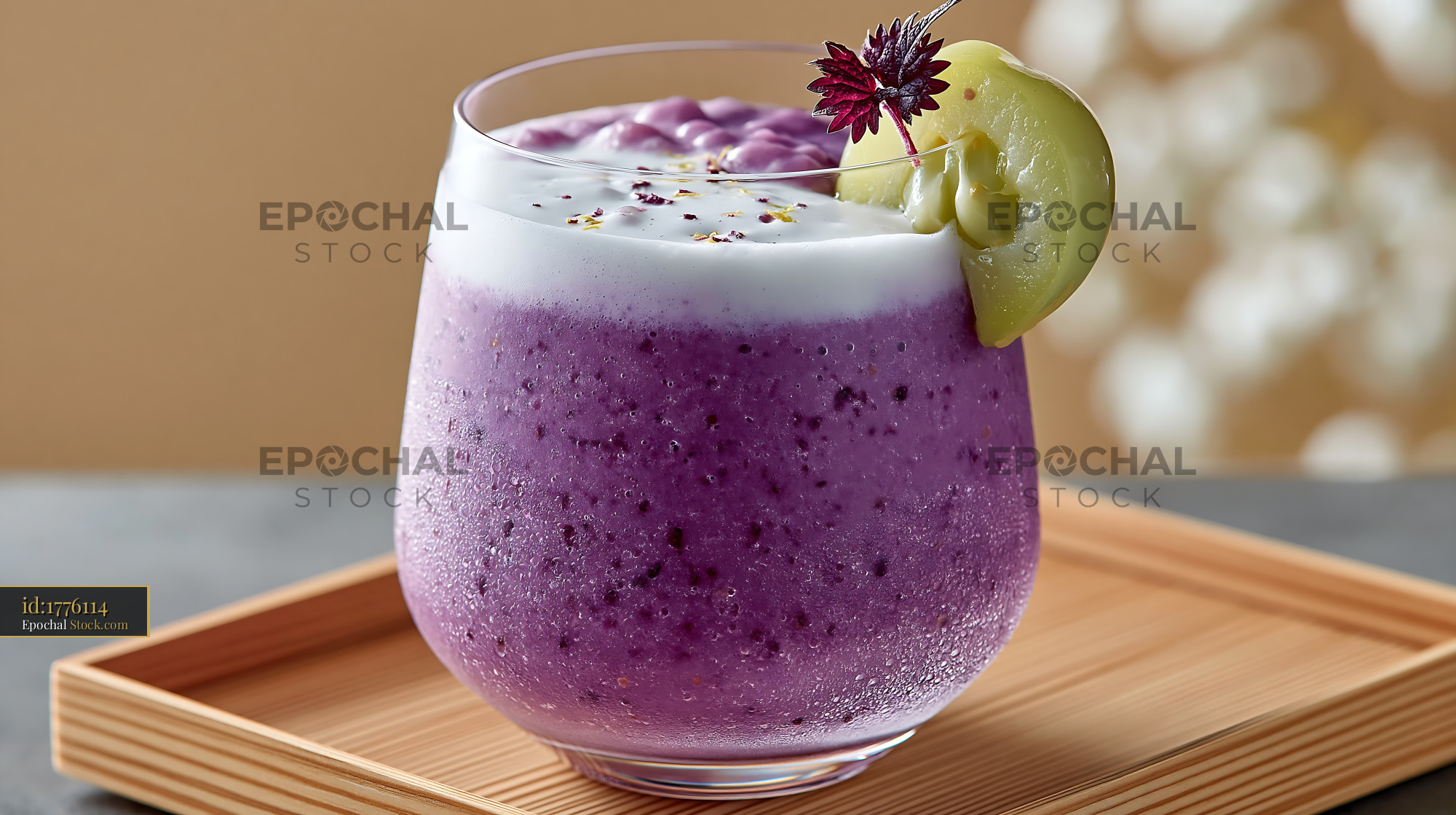 Purple kyoho grape smoothie with creamy foam and garnish on wooden tra - stock photo