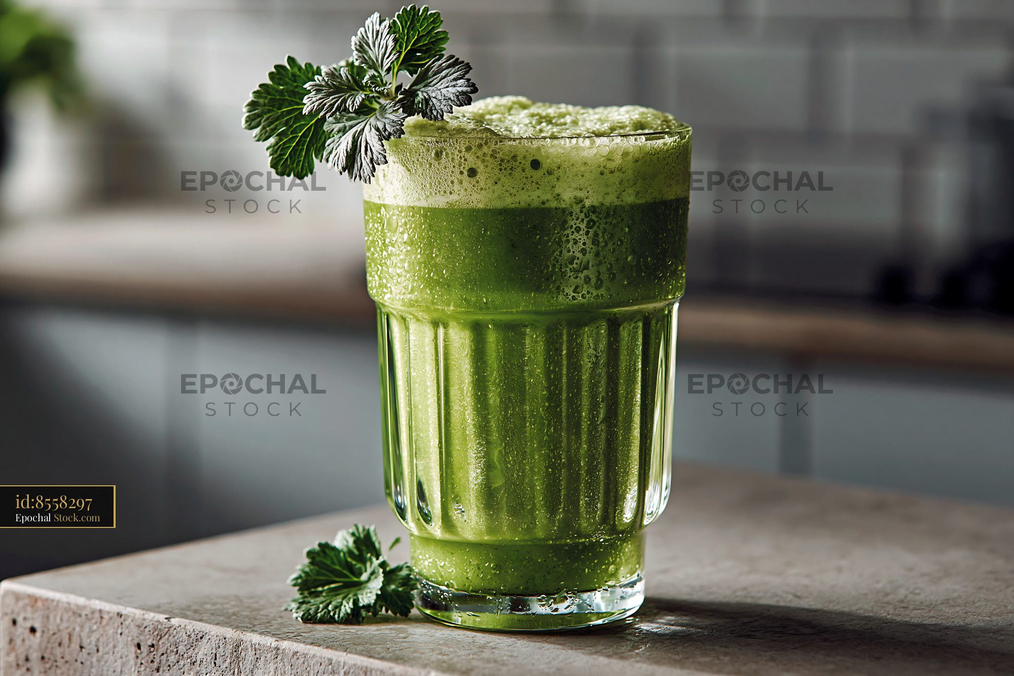 Mugwort herb smoothie with fresh garnish on a kitchen counter - stock photo