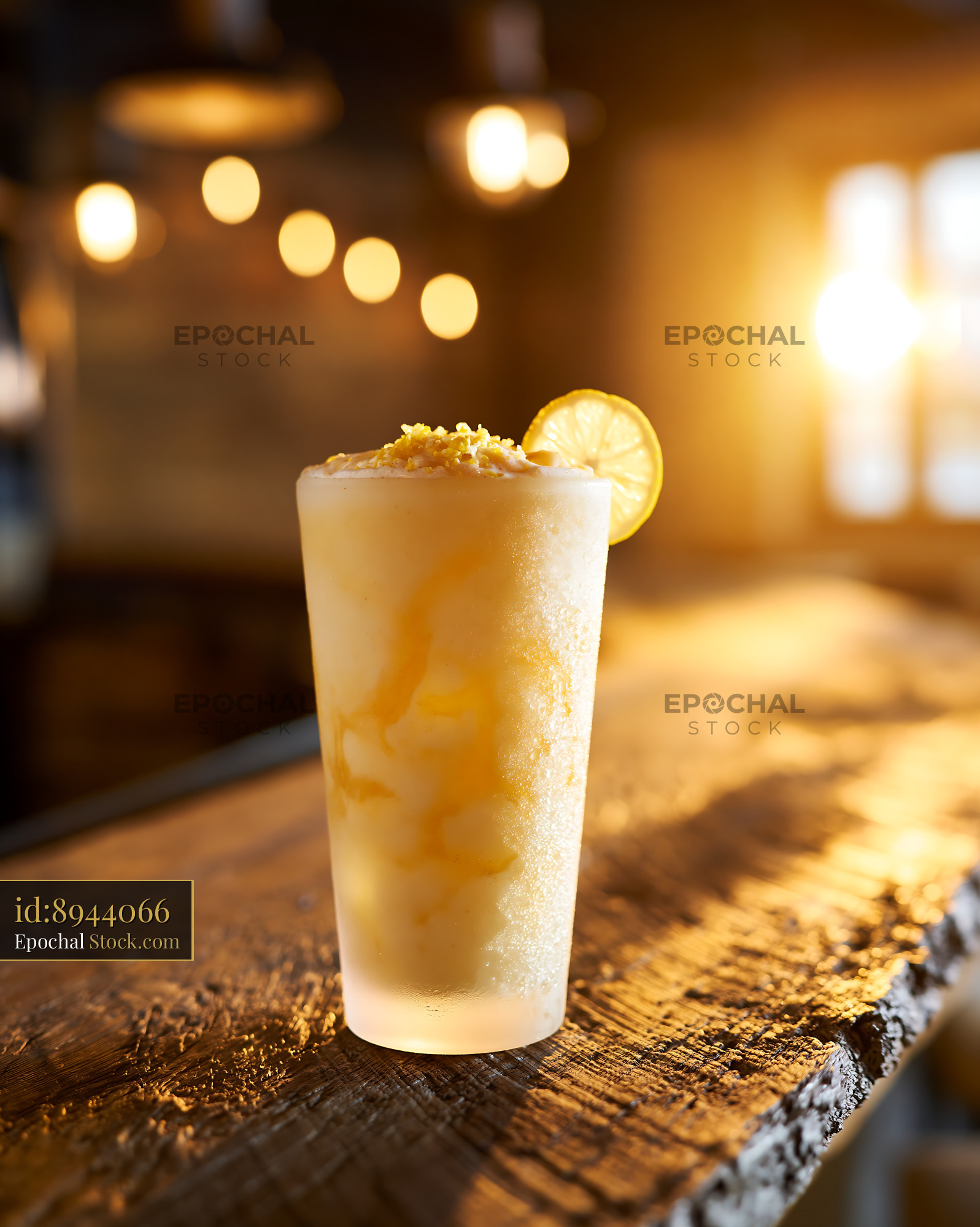 Refreshing yuzu honey smoothie on a rustic wooden bar at sunset - stock photo